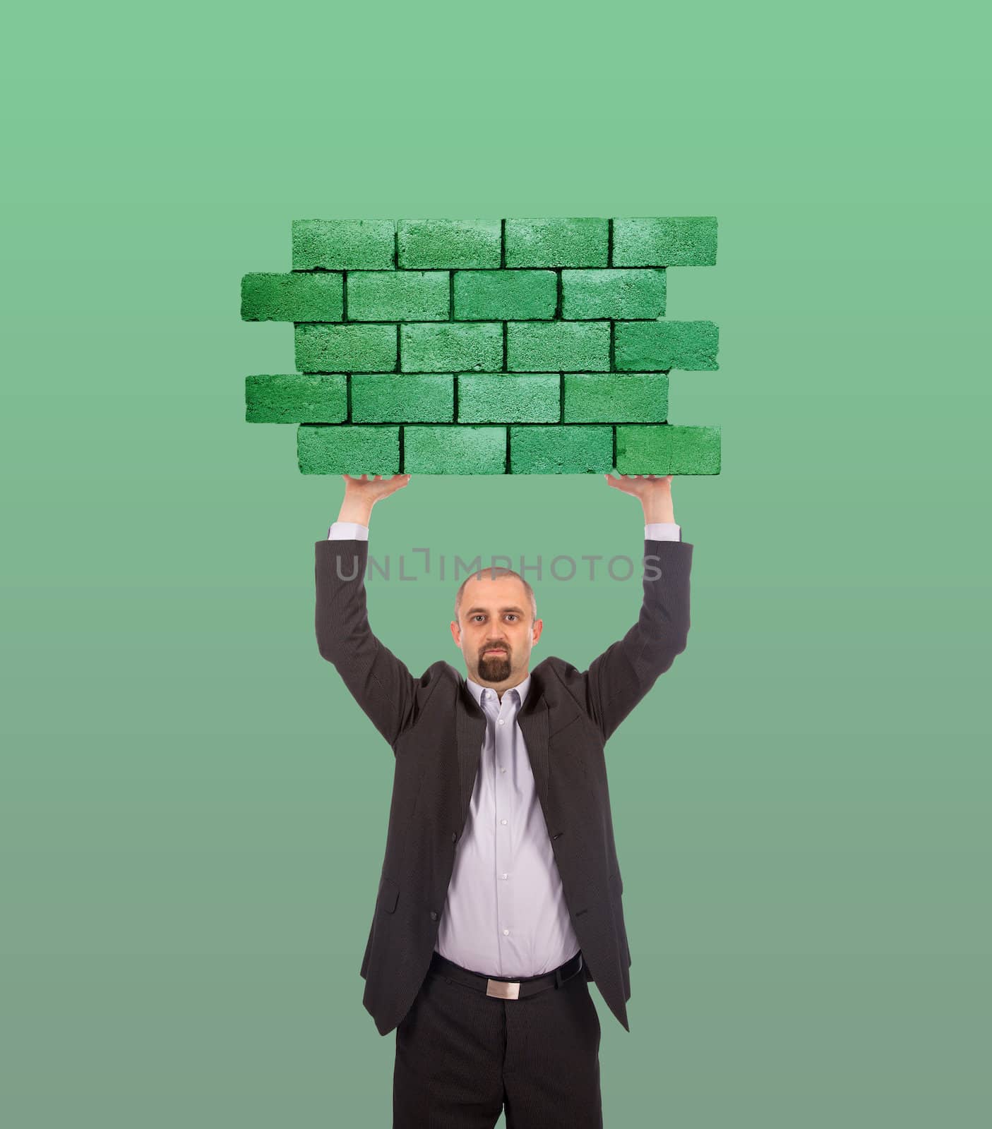 Businessman holding a large piece of a brick wall, flag of Lybia, isolated on national flag