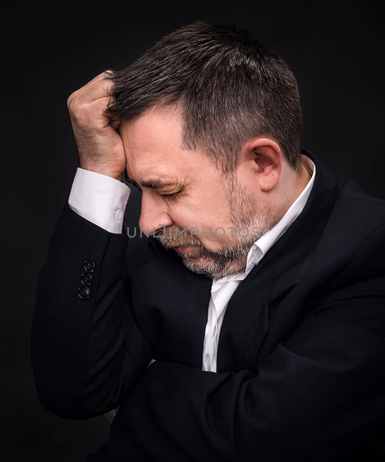 Headache. Portrait of an elderly man with face closed by hand