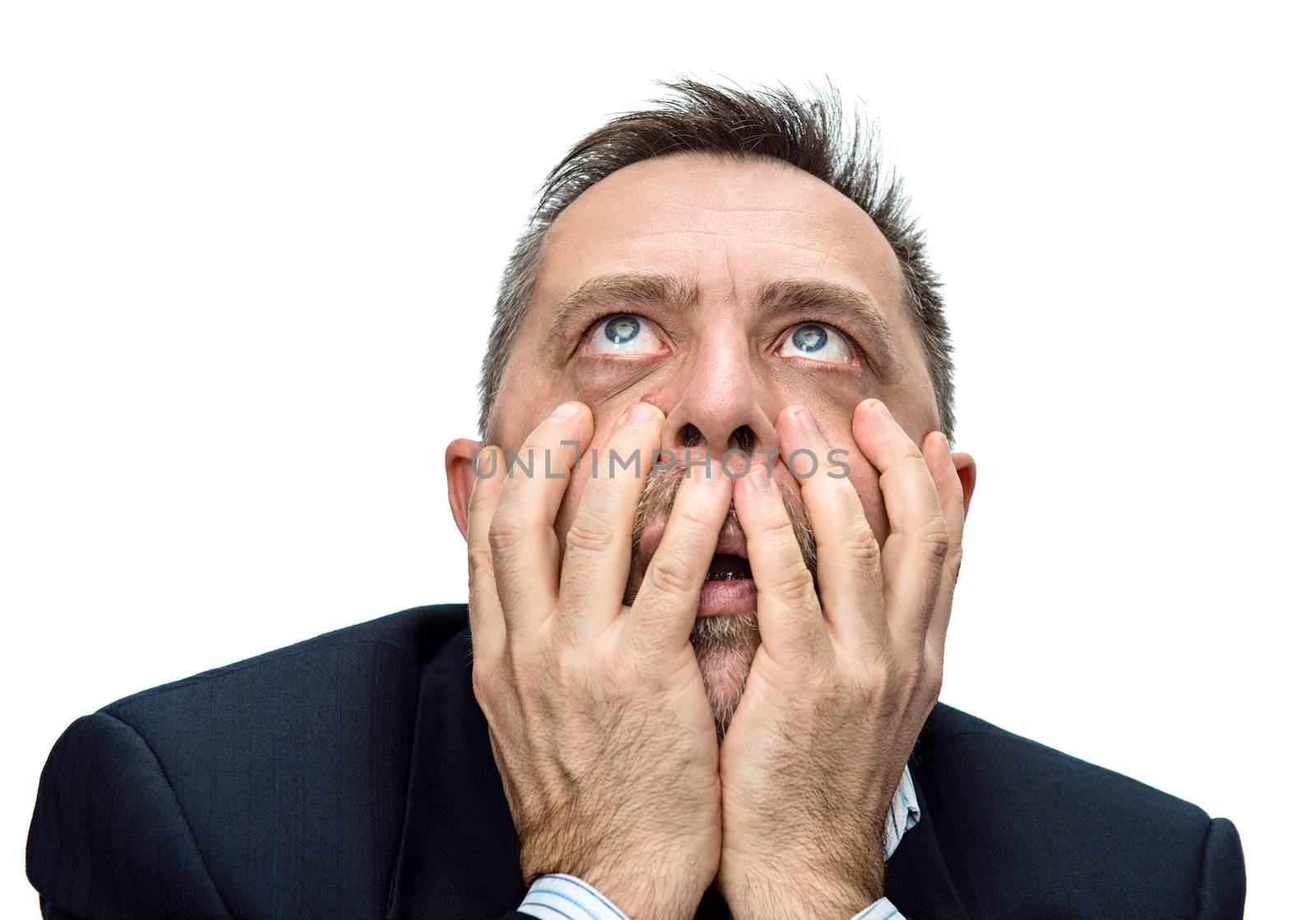 Fear and horror. Portrait of an middle age man with face closed by hands. Isolated on white
