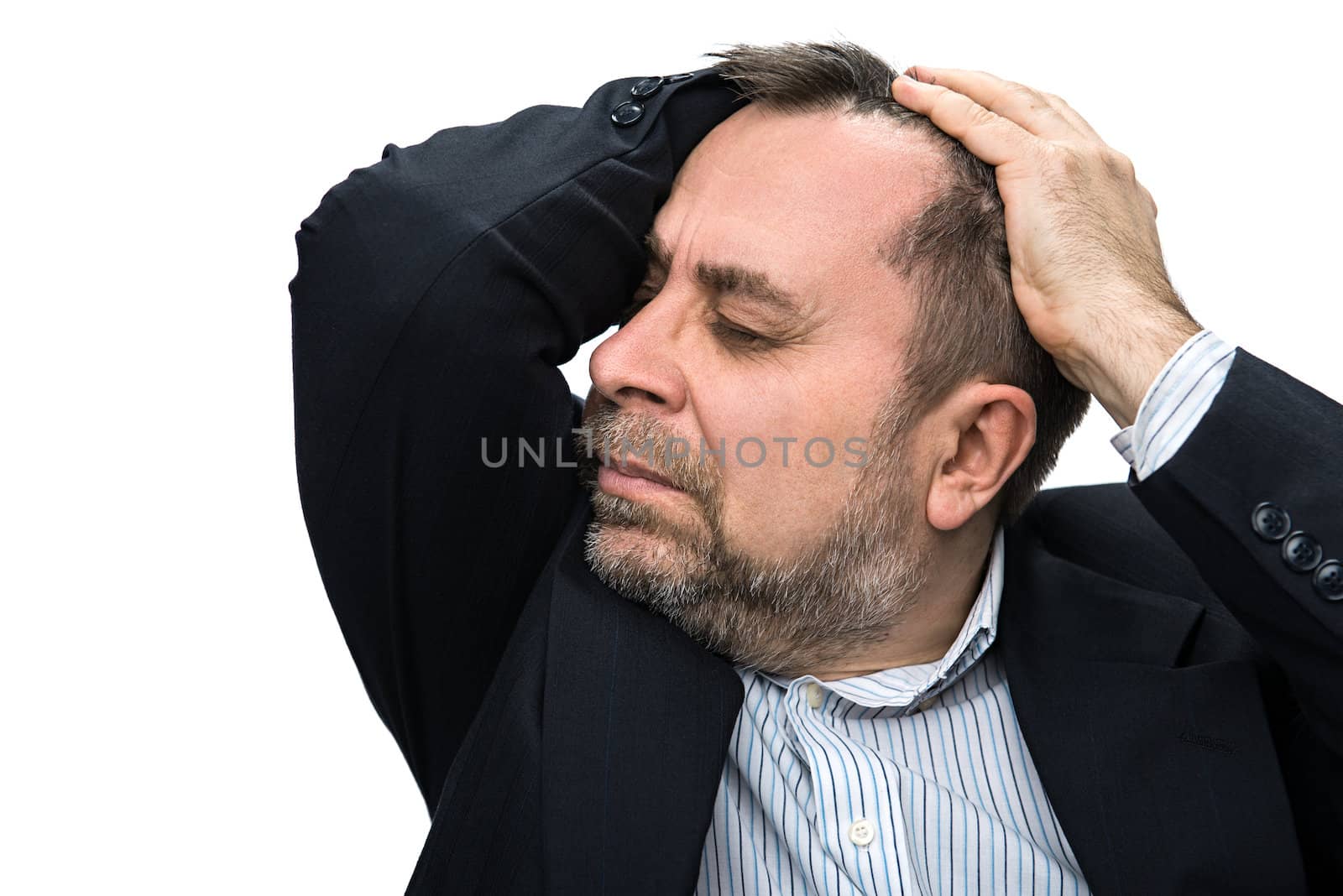 Middle-aged man suffering from a headache and holding his head by hands. Isolated on white