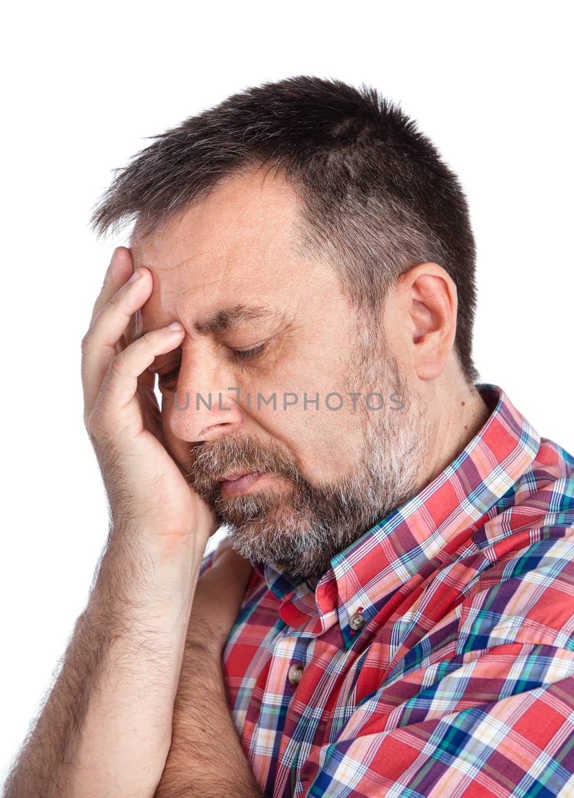Headache. Portrait of an middle age man with face closed by hand. Isolated on white