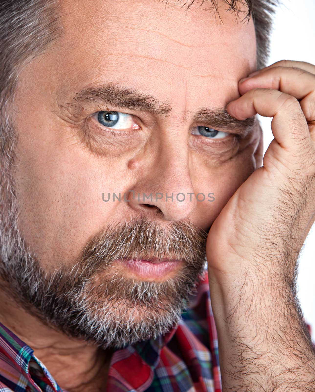 Portrait of a thoughtful middle age man with hand near the face