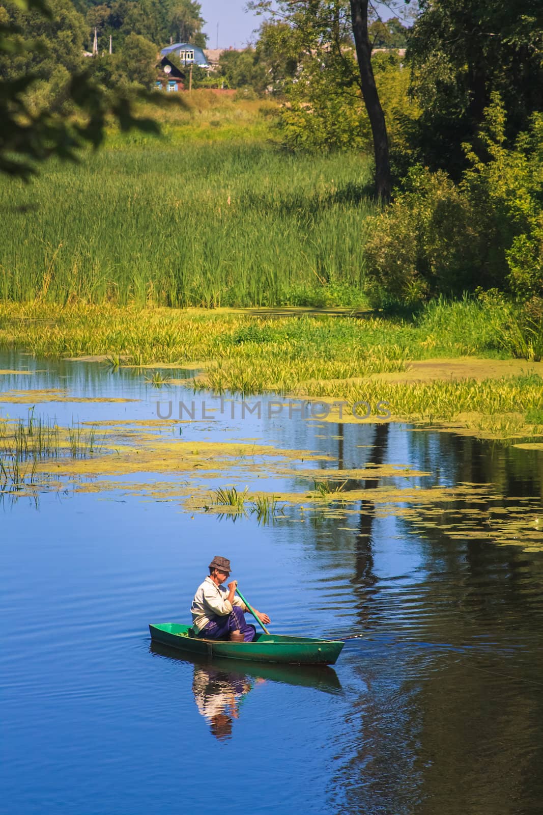 Old Man Fishing Out Of A Row Boat