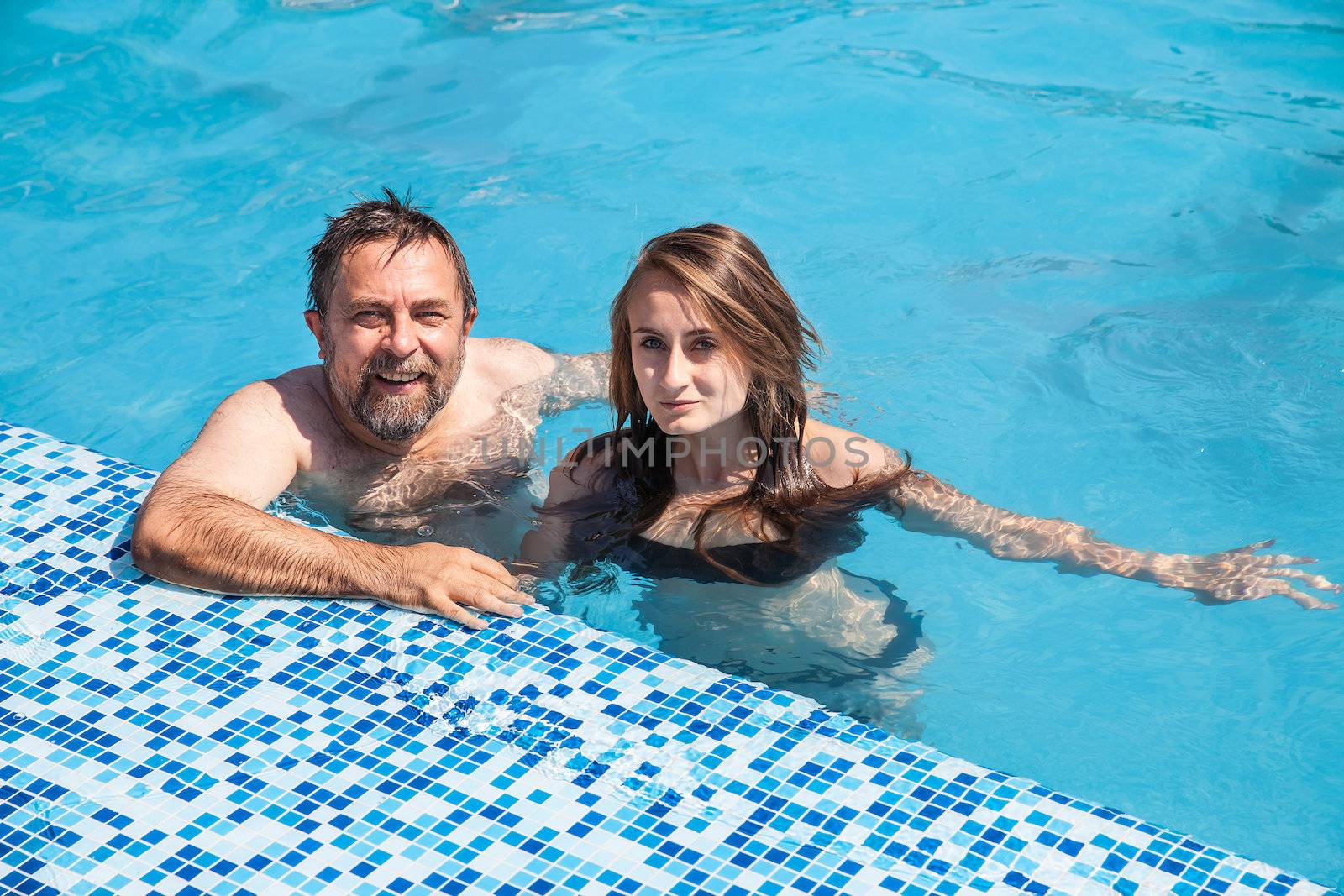  Father and daughter swimming in the poo by palinchak