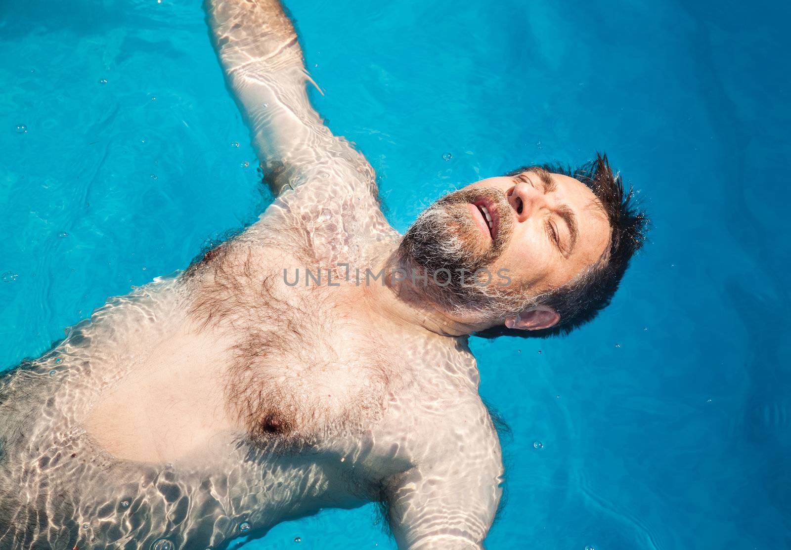 Middle-aged man in a swimming pool by palinchak