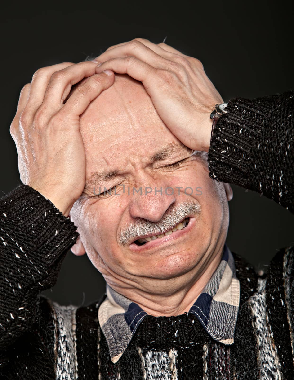 elderly man suffering from a headache