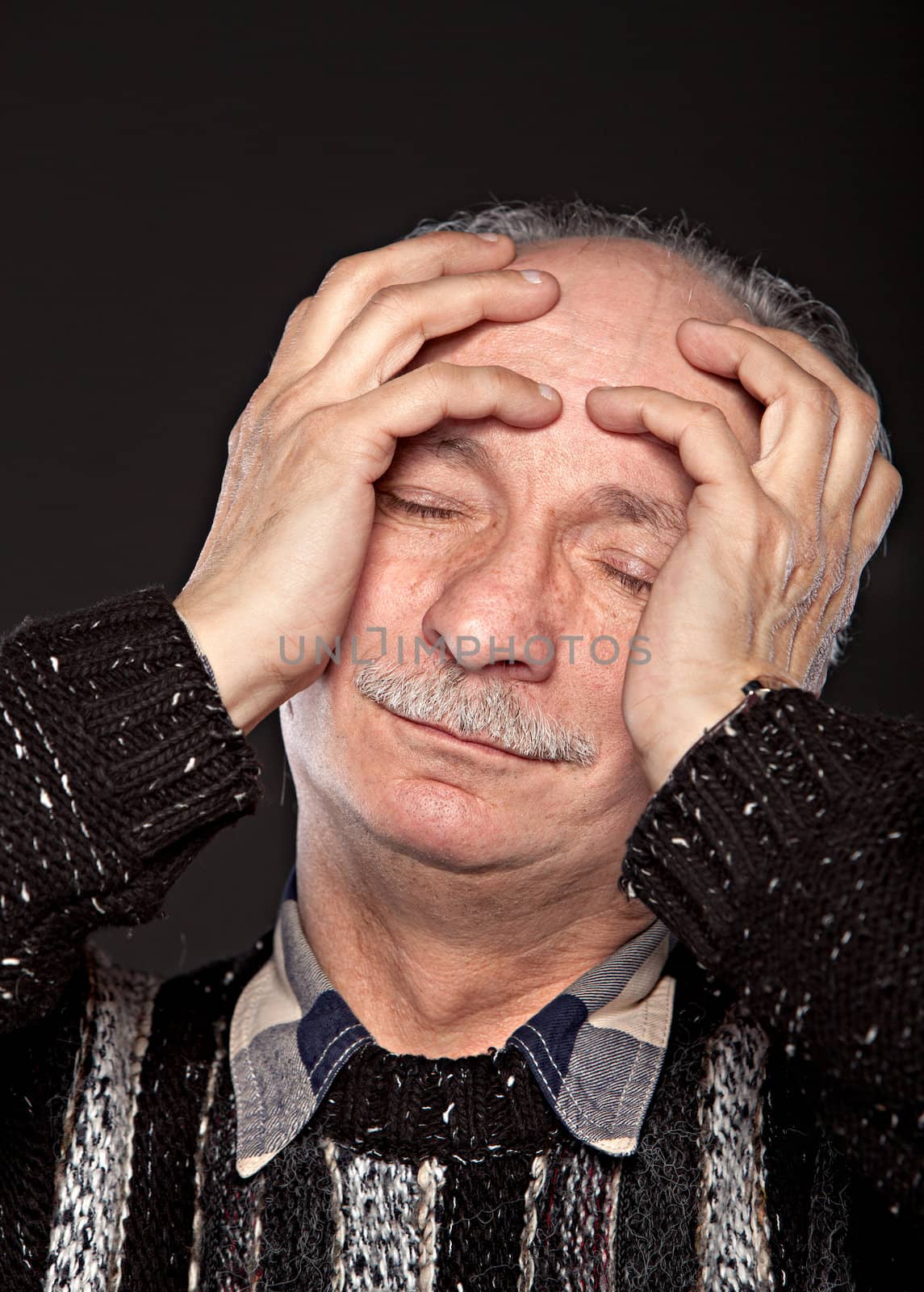  Depression. Elderly man suffering from a headache