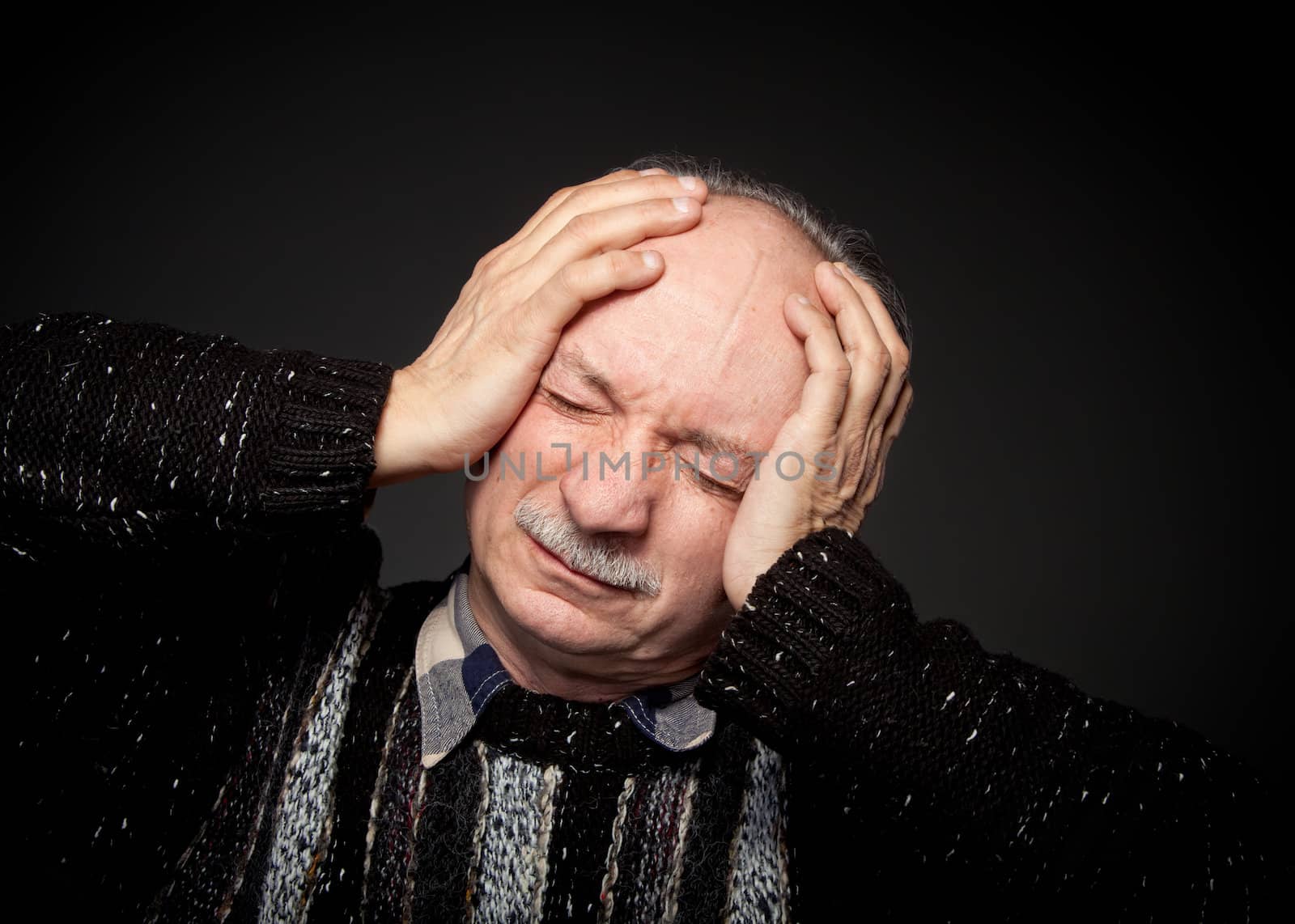 Pain. Elderly man suffering from a headache