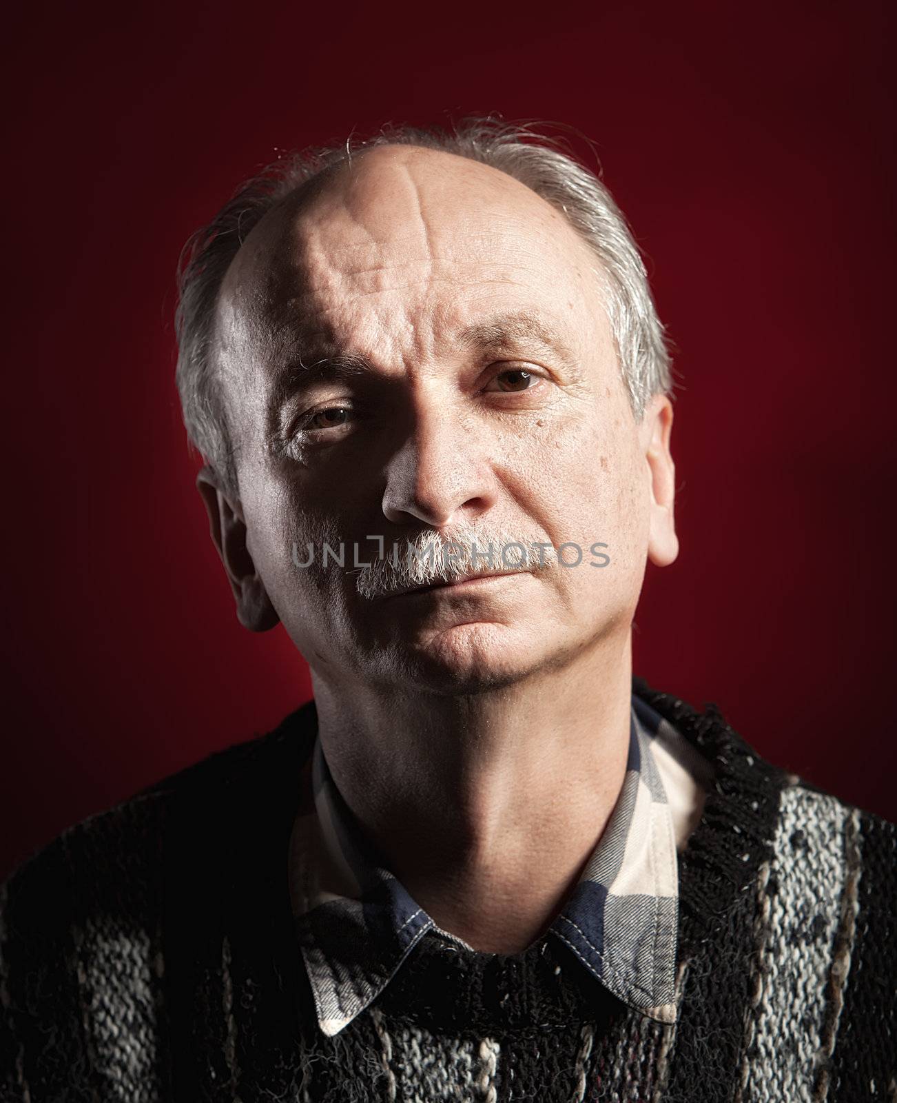 Portrait of handsome senior man with a tired expression