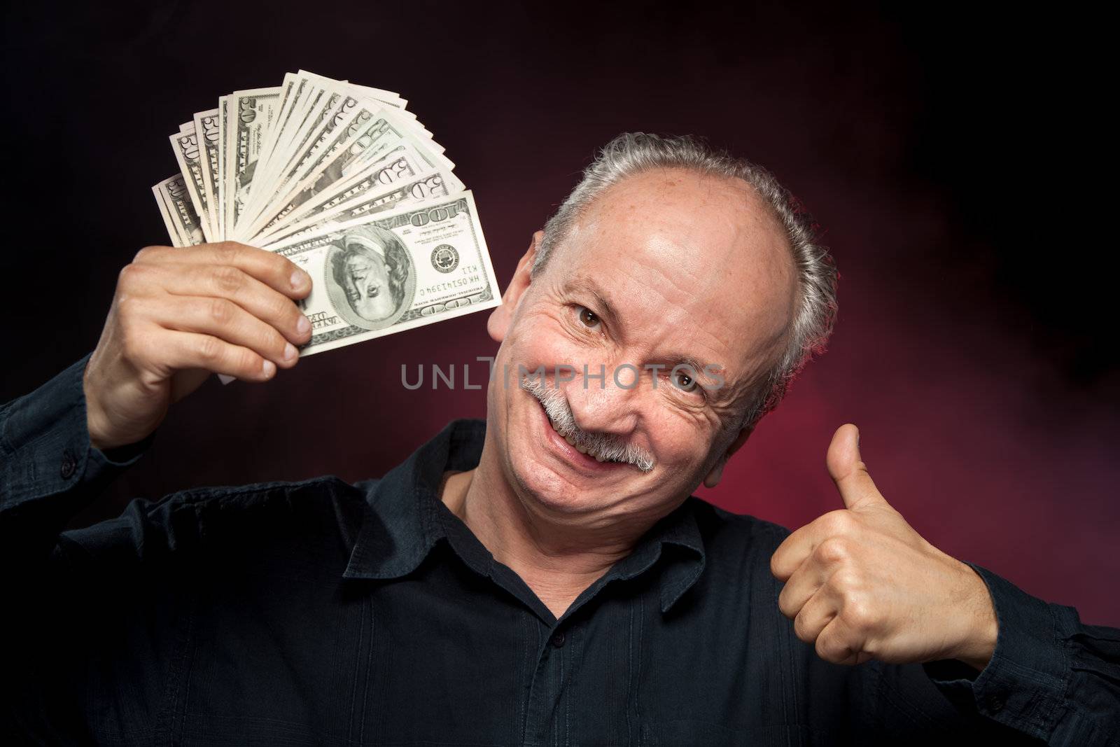 elderly man showing fan of money by palinchak