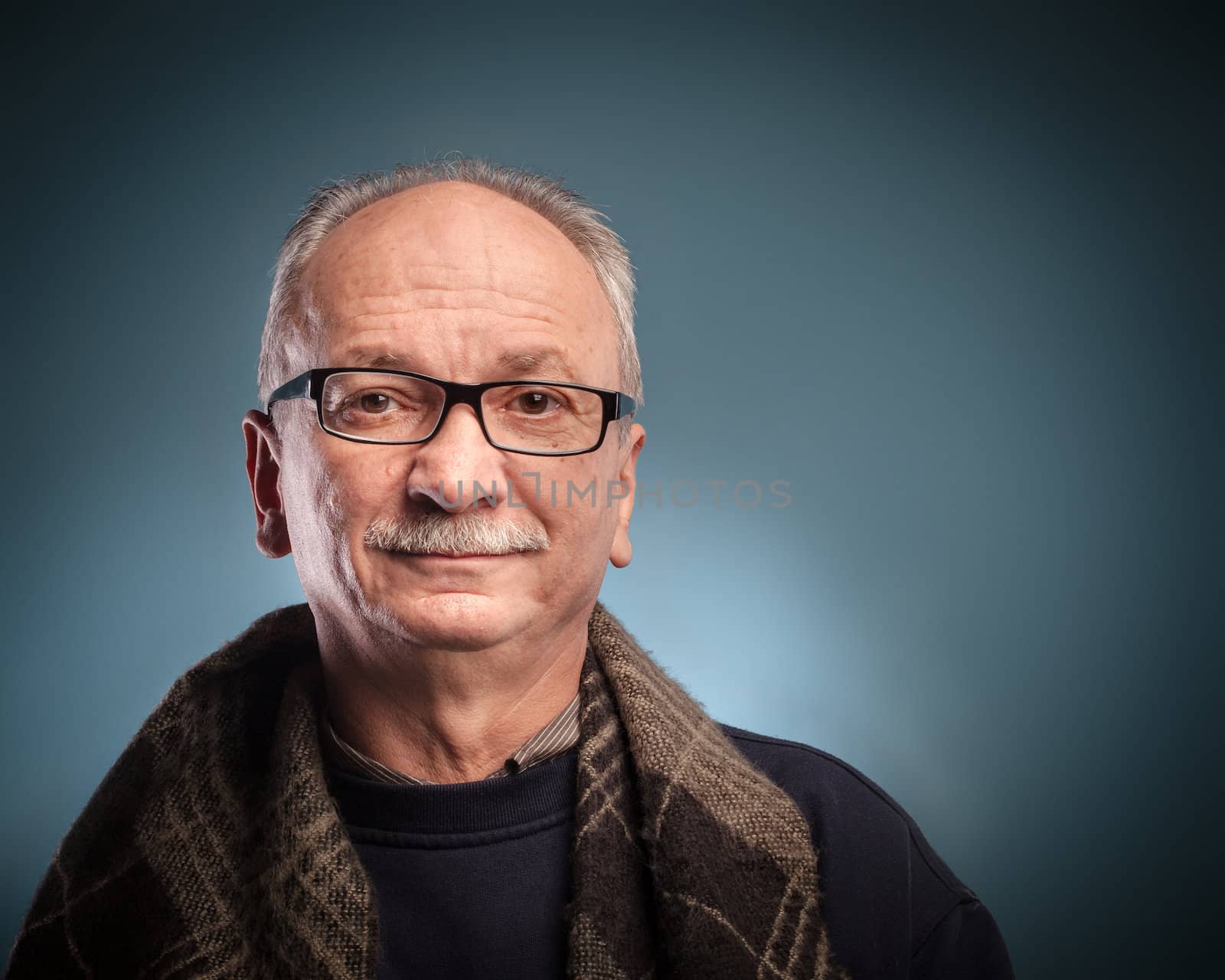 An elderly man with glasses looks skeptically