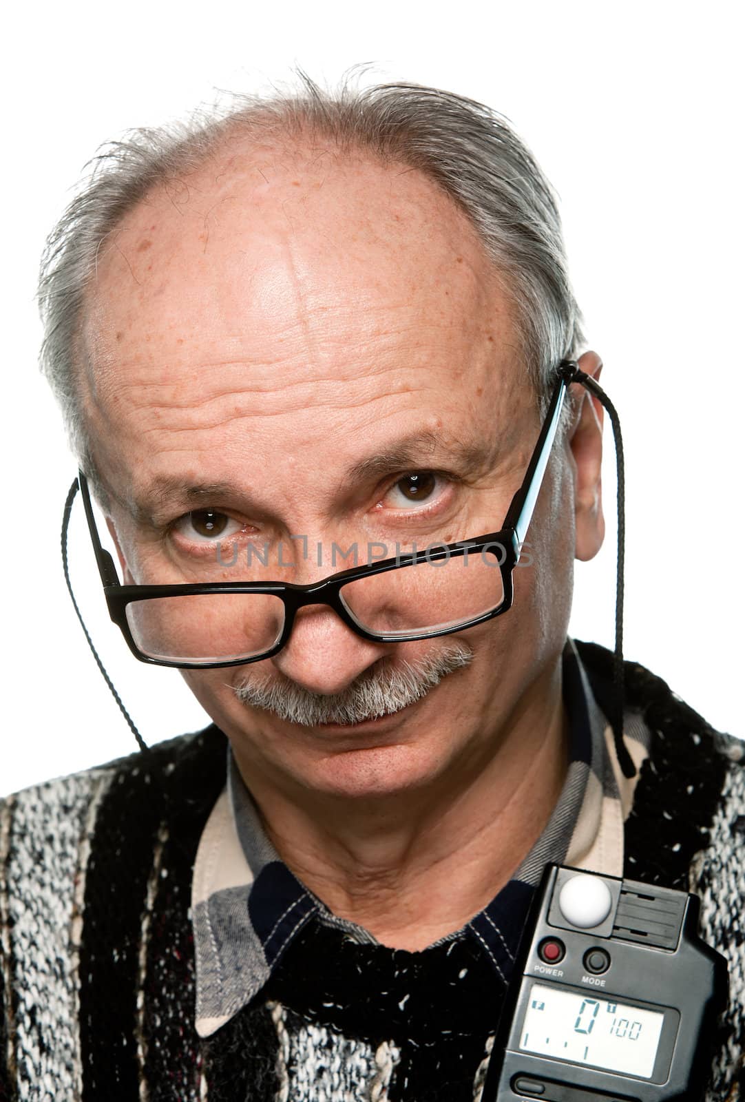 Portrait of a senior photographer with a flash meter and glasses