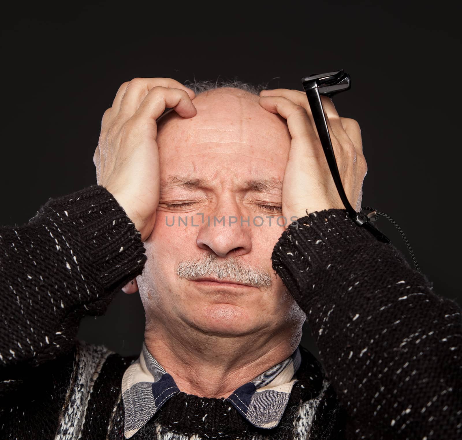 Elderly man suffering from a headache