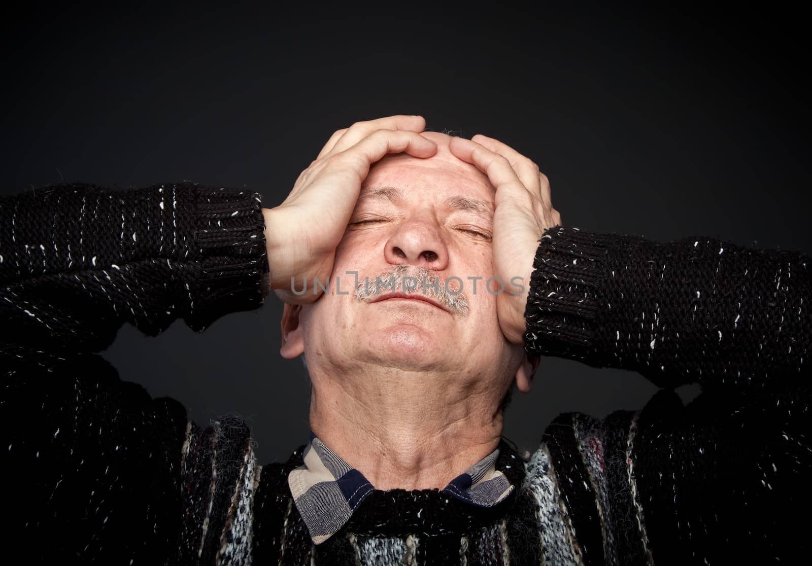 Pain. Elderly man suffering from a headache