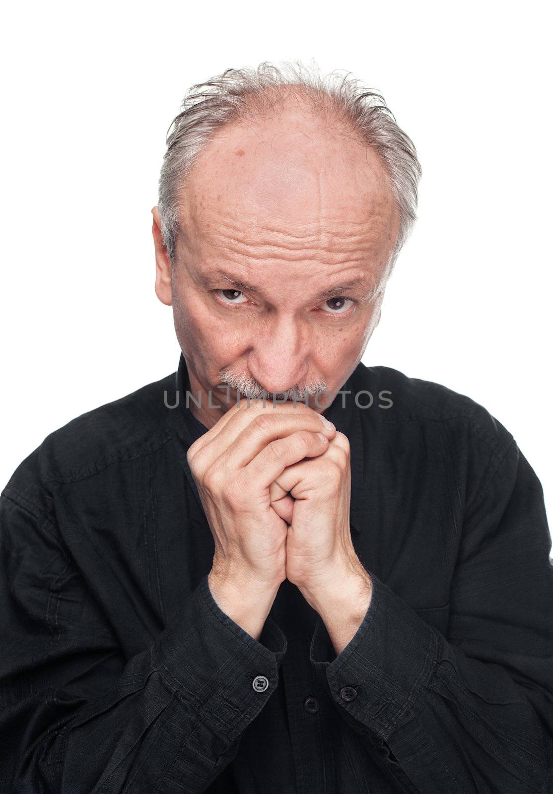 Lonely elderly man with hands joined, praying