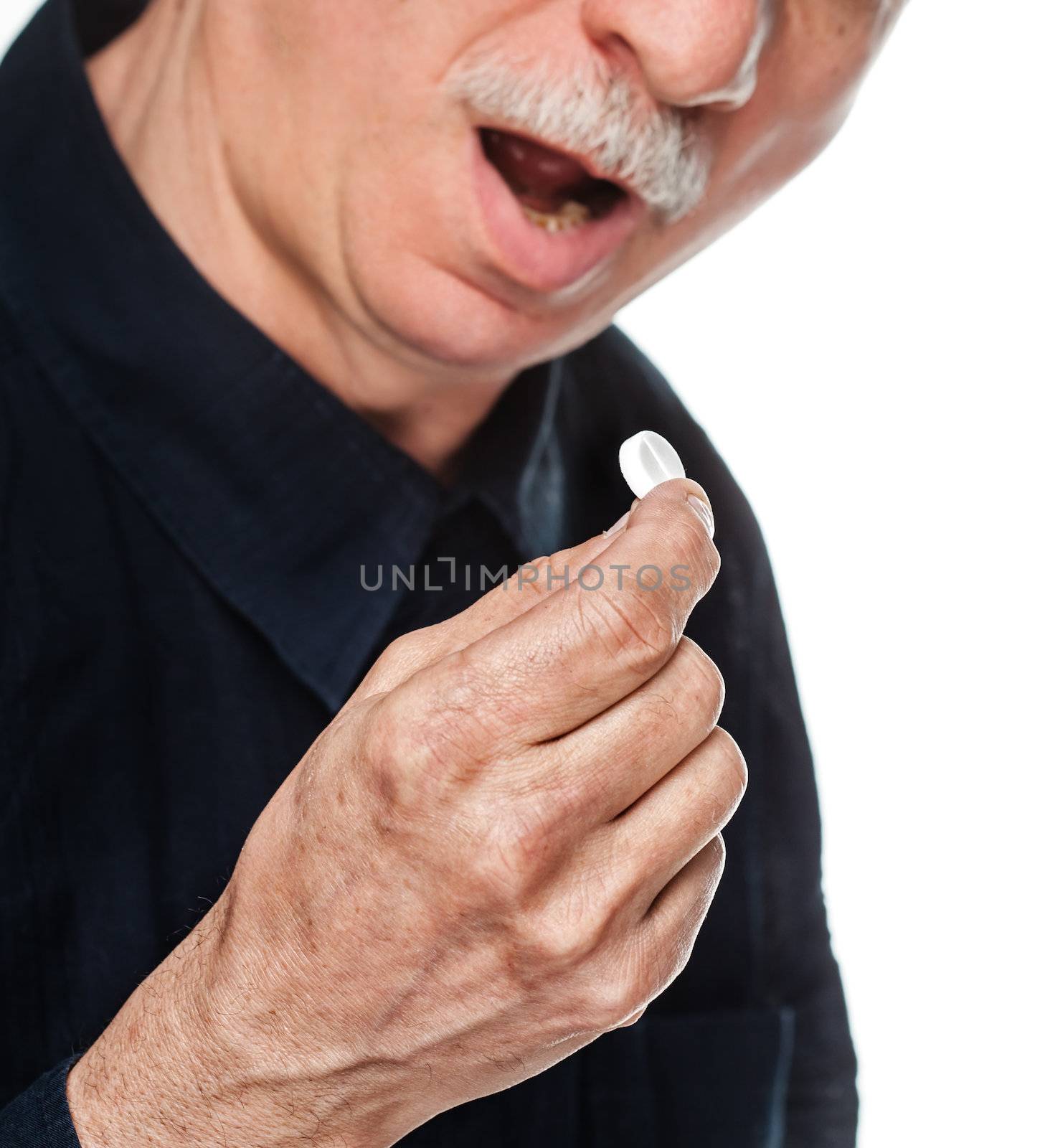 Old man wants to take a pill. Focus on hand