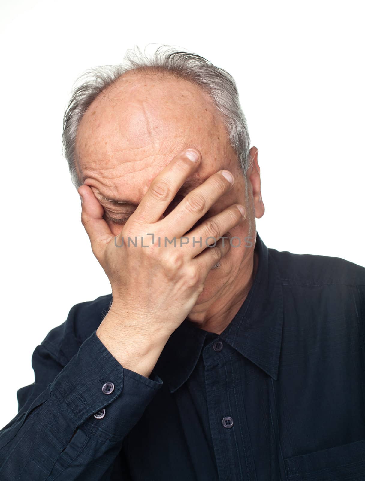 Pain. Elderly man covers his face with hand