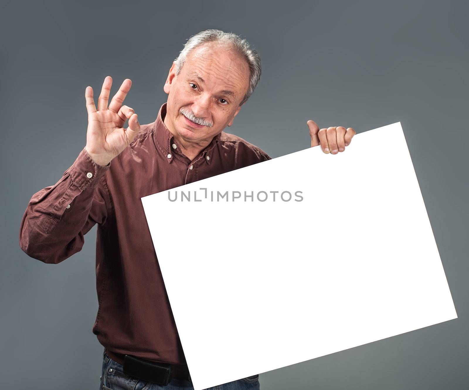 old man holding empty billboard and shows sign OK