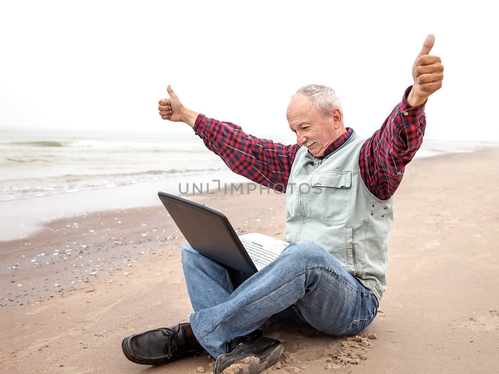 Old man with notebook on beach by palinchak