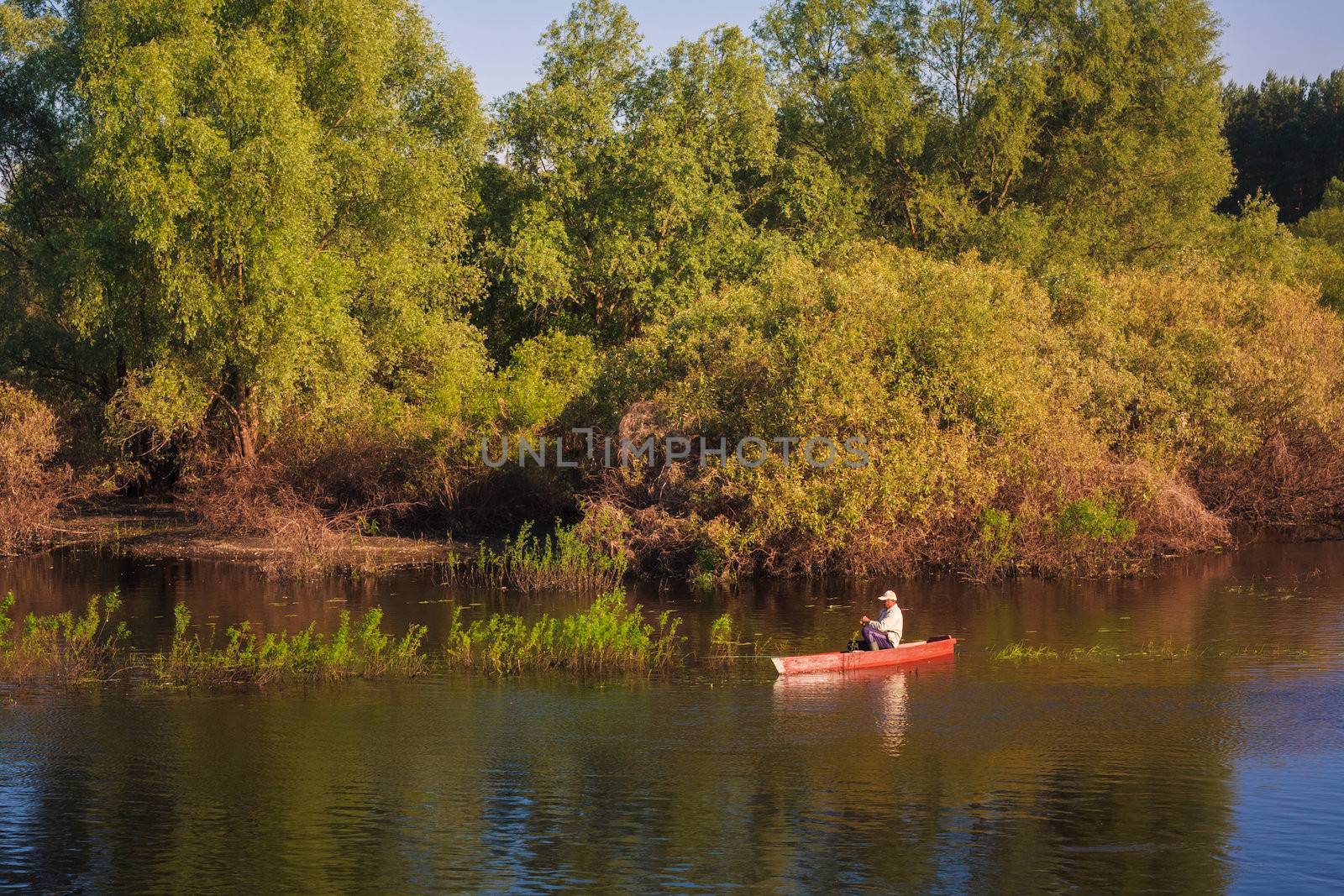 Old Man Fishing Out Of A Row Boat