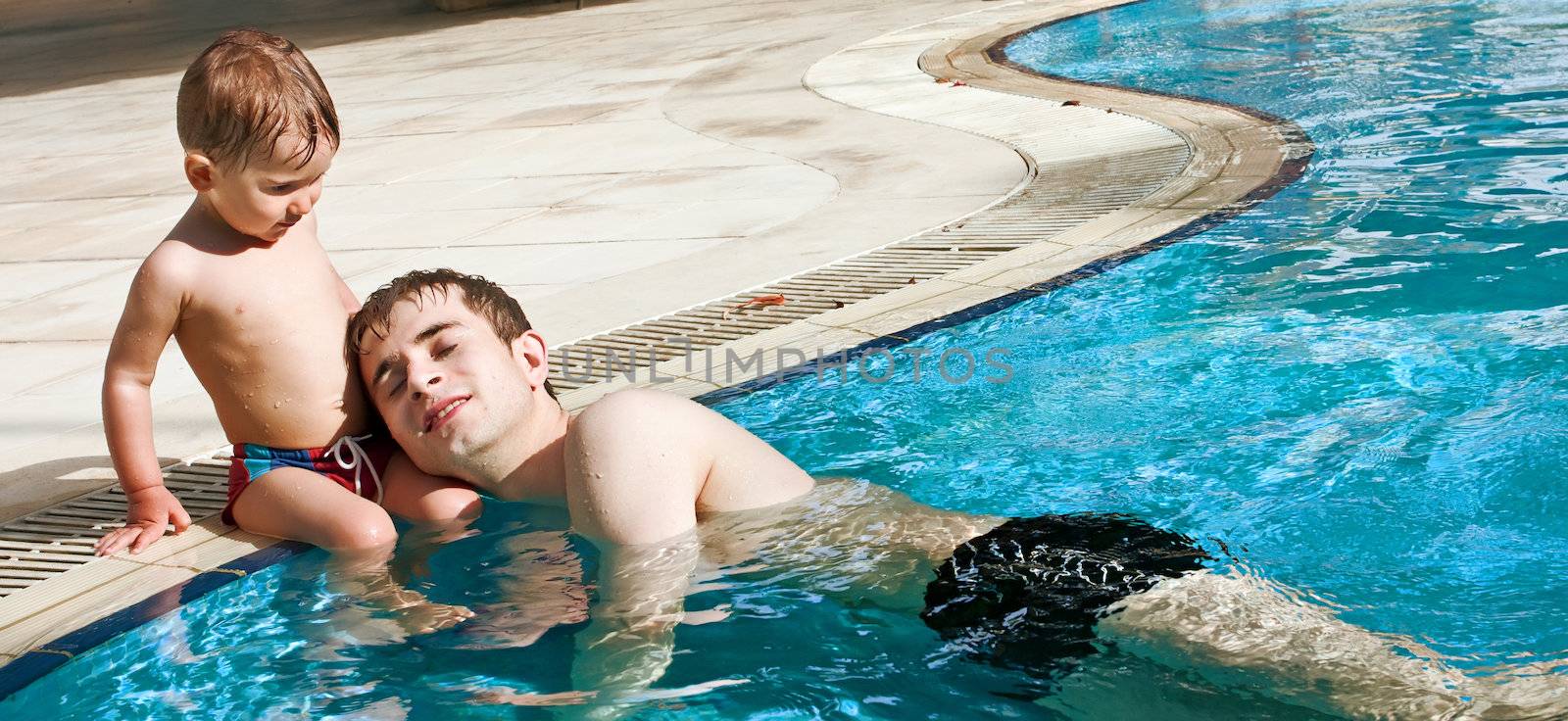 Little boy and his father in the pool