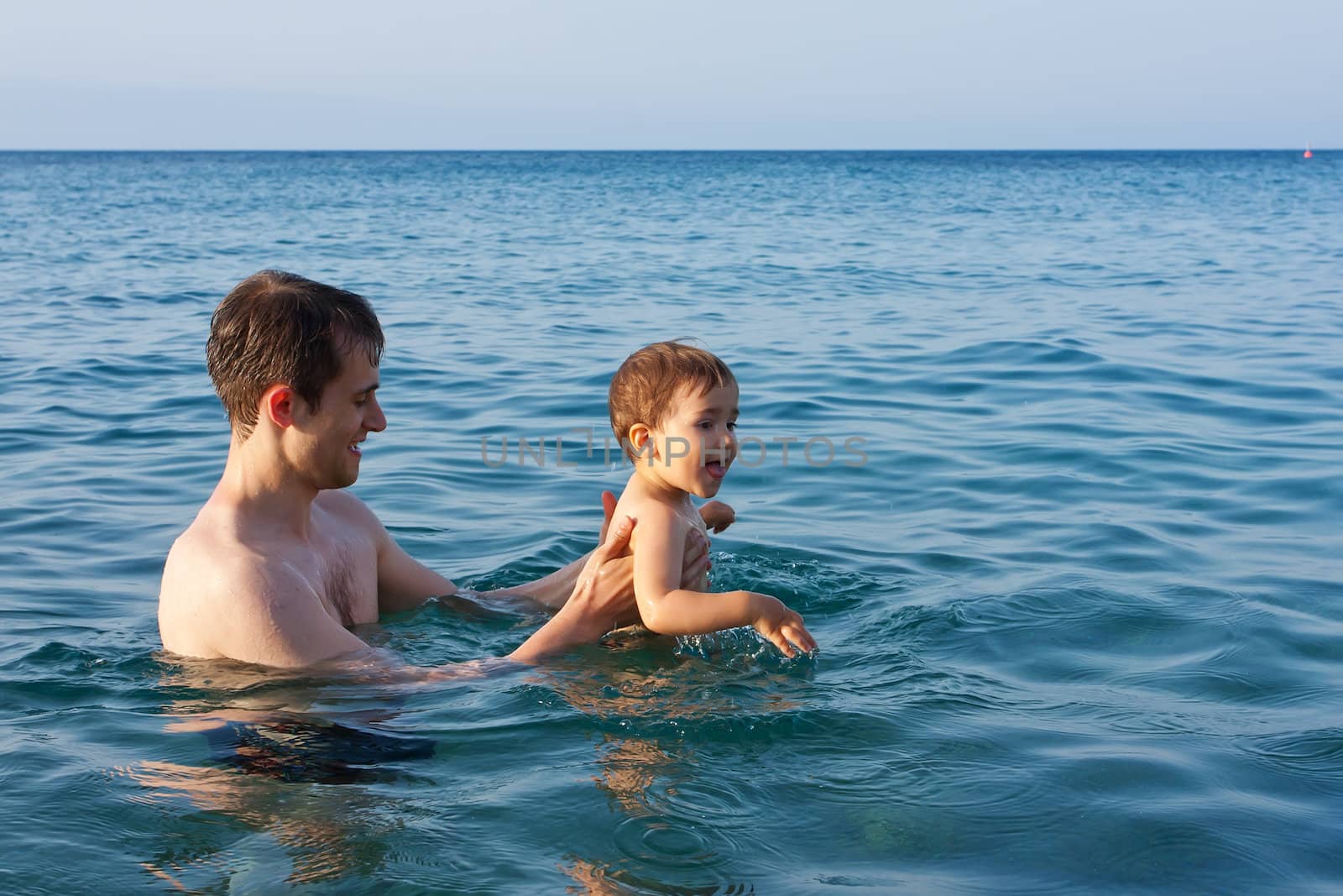 Father teaching his son to swim