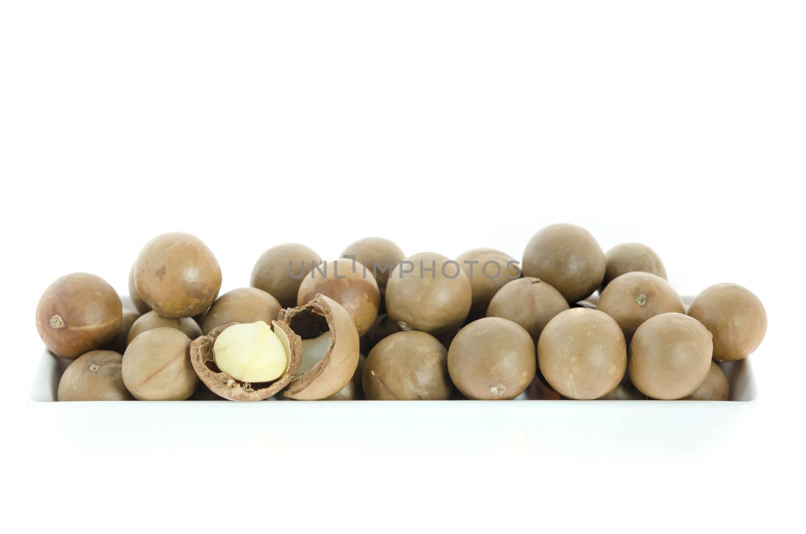 macadamia in  white bowl  on white background