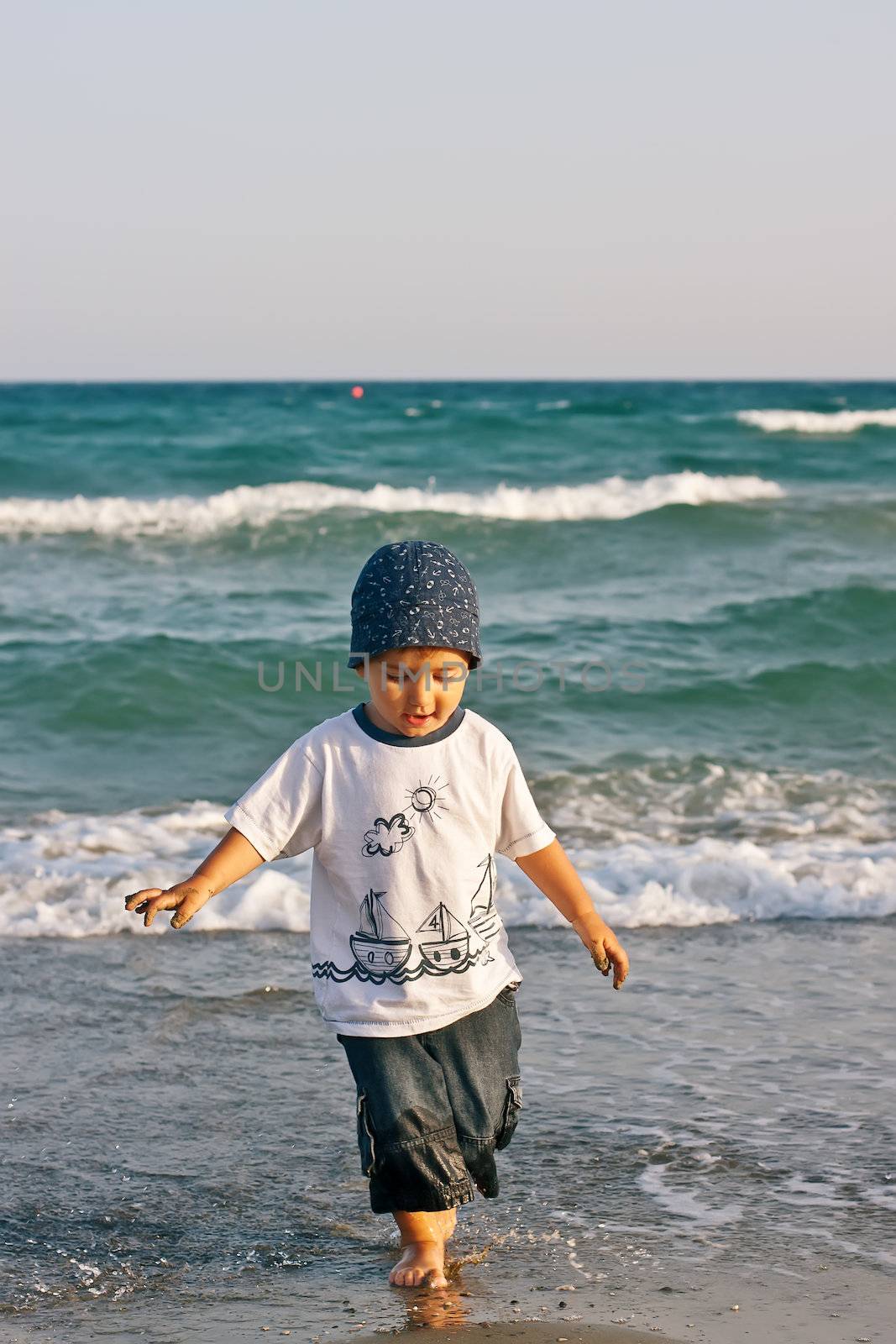 Boy walks on the beach