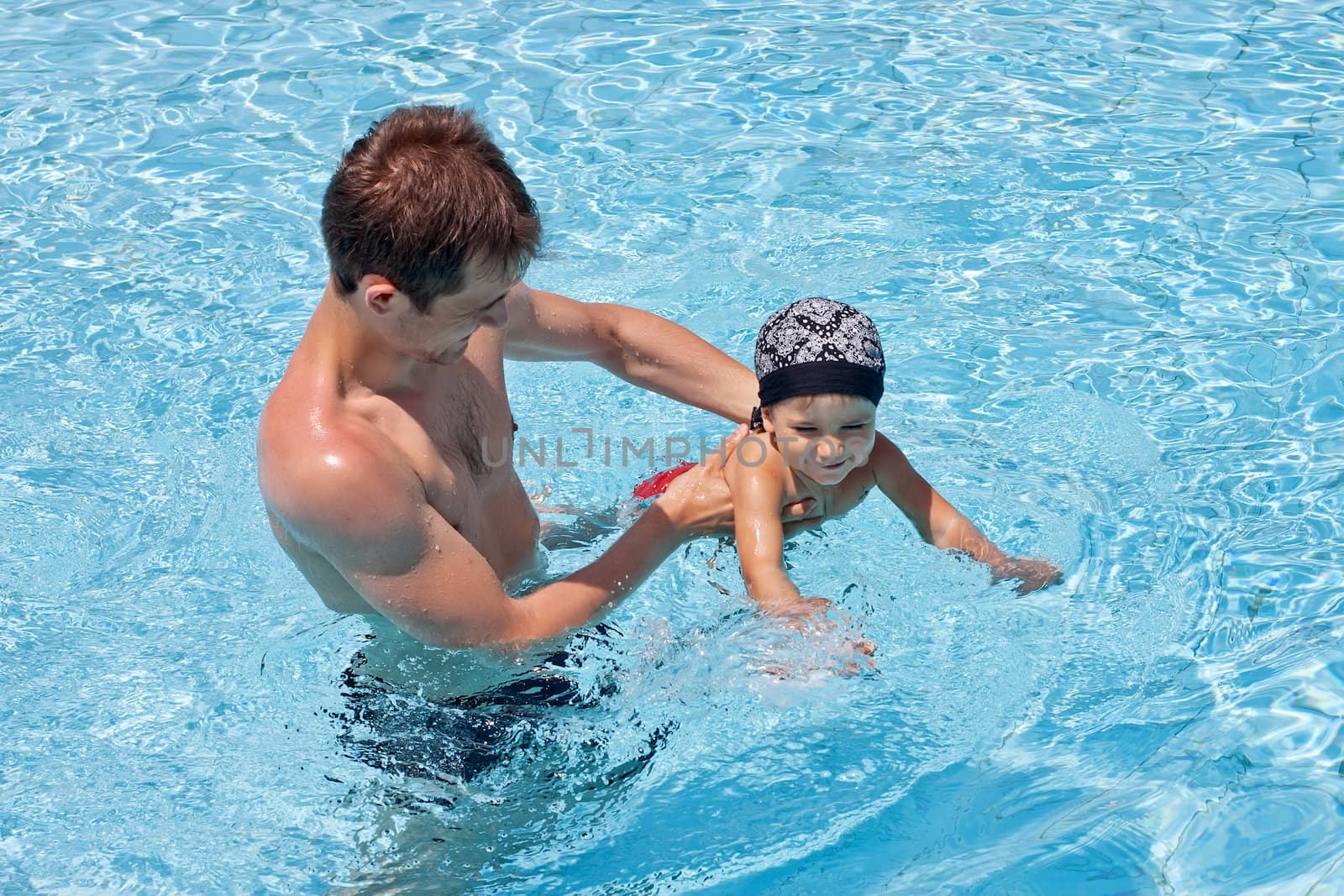 Father teaching his son to swim