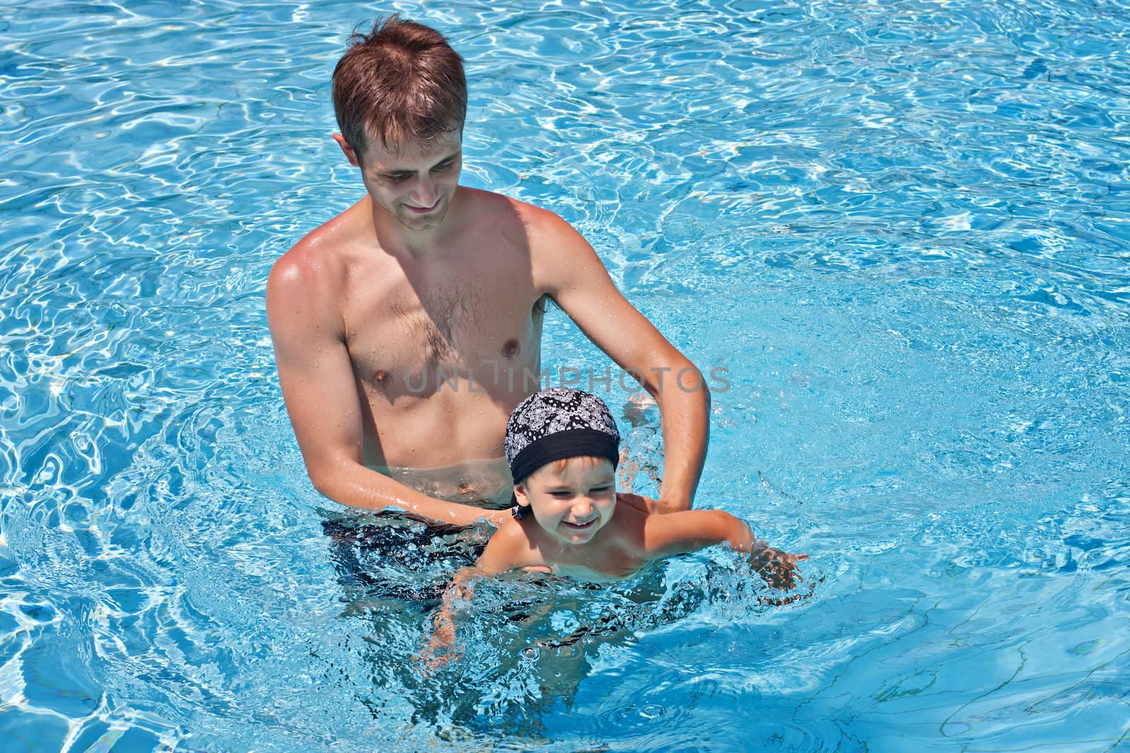 Father teaching his son to swim