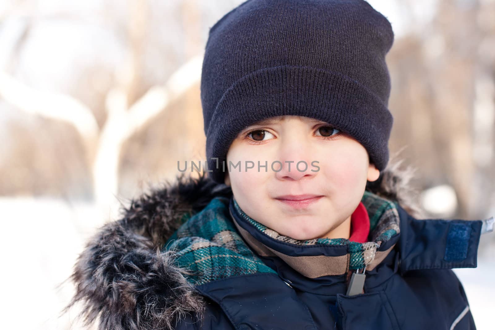 Winter portrait of  boy in snow background