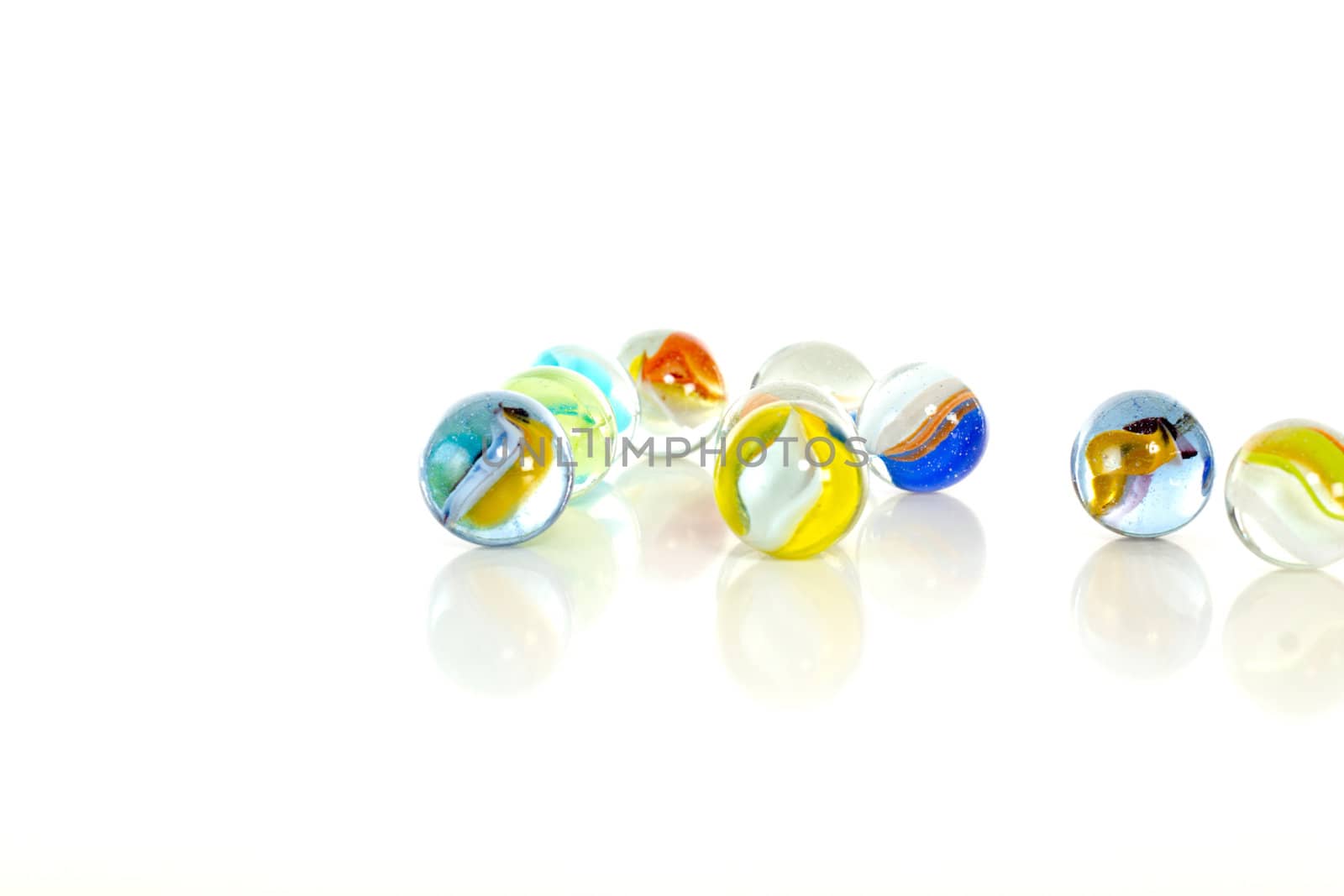 Colourful marbles on white background