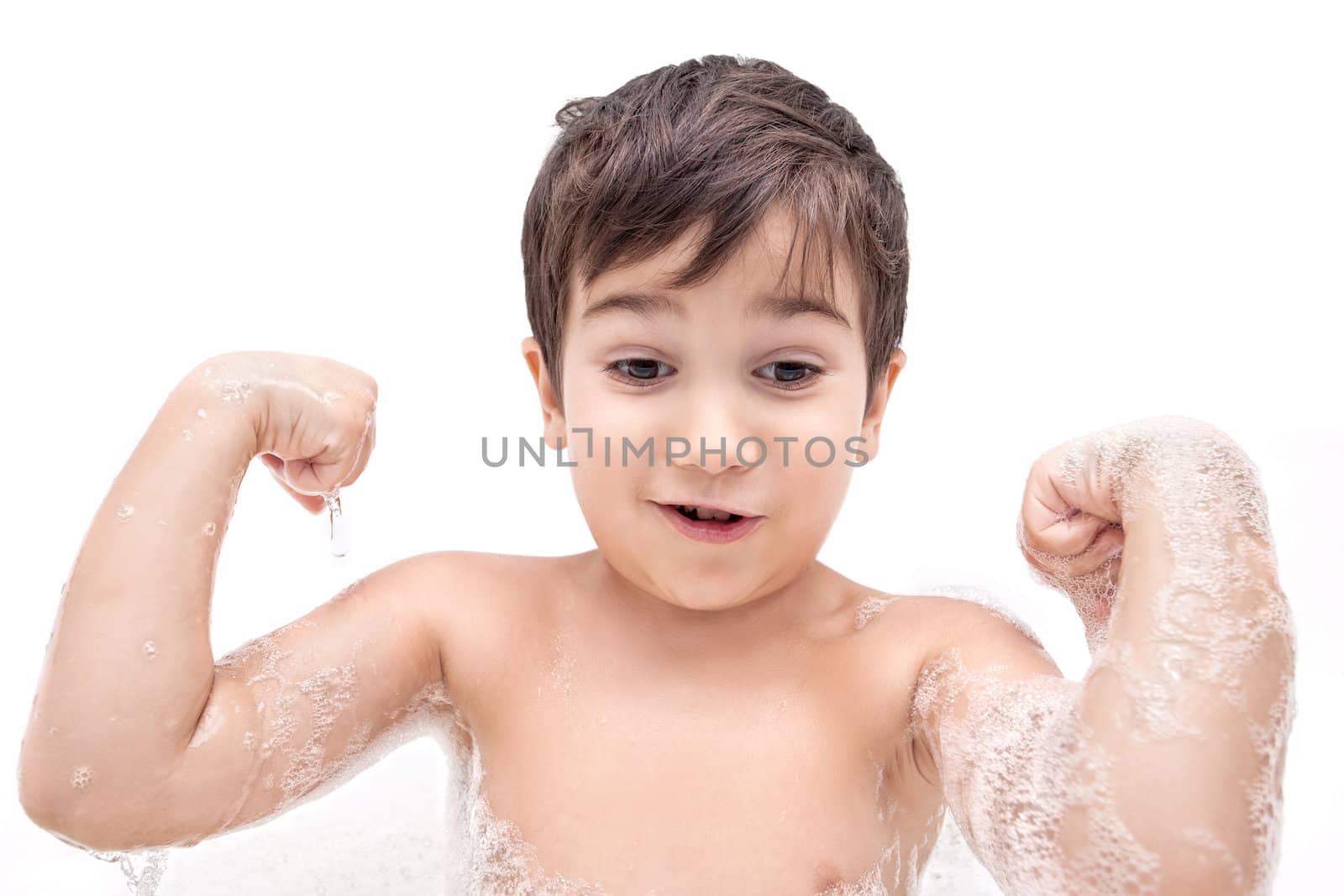 Boy washing in the bathroom and shows muscles