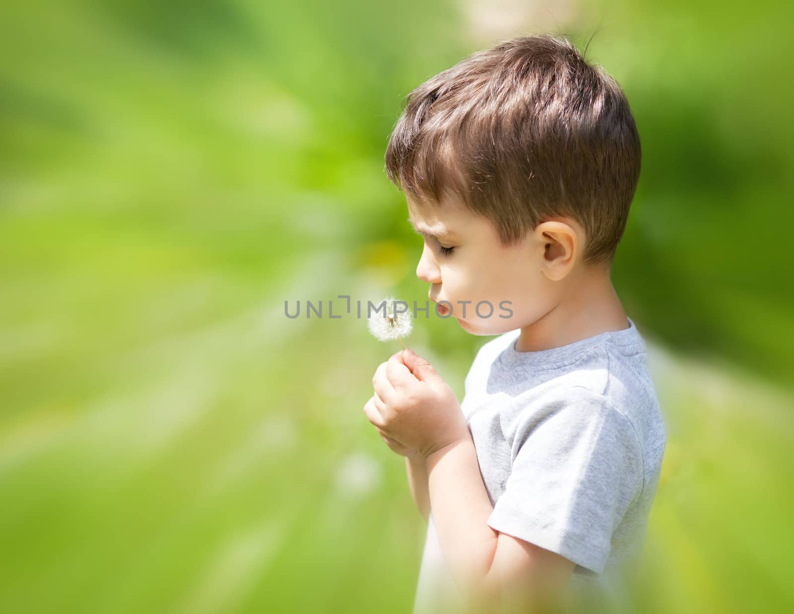 boy blowing dandelion by palinchak