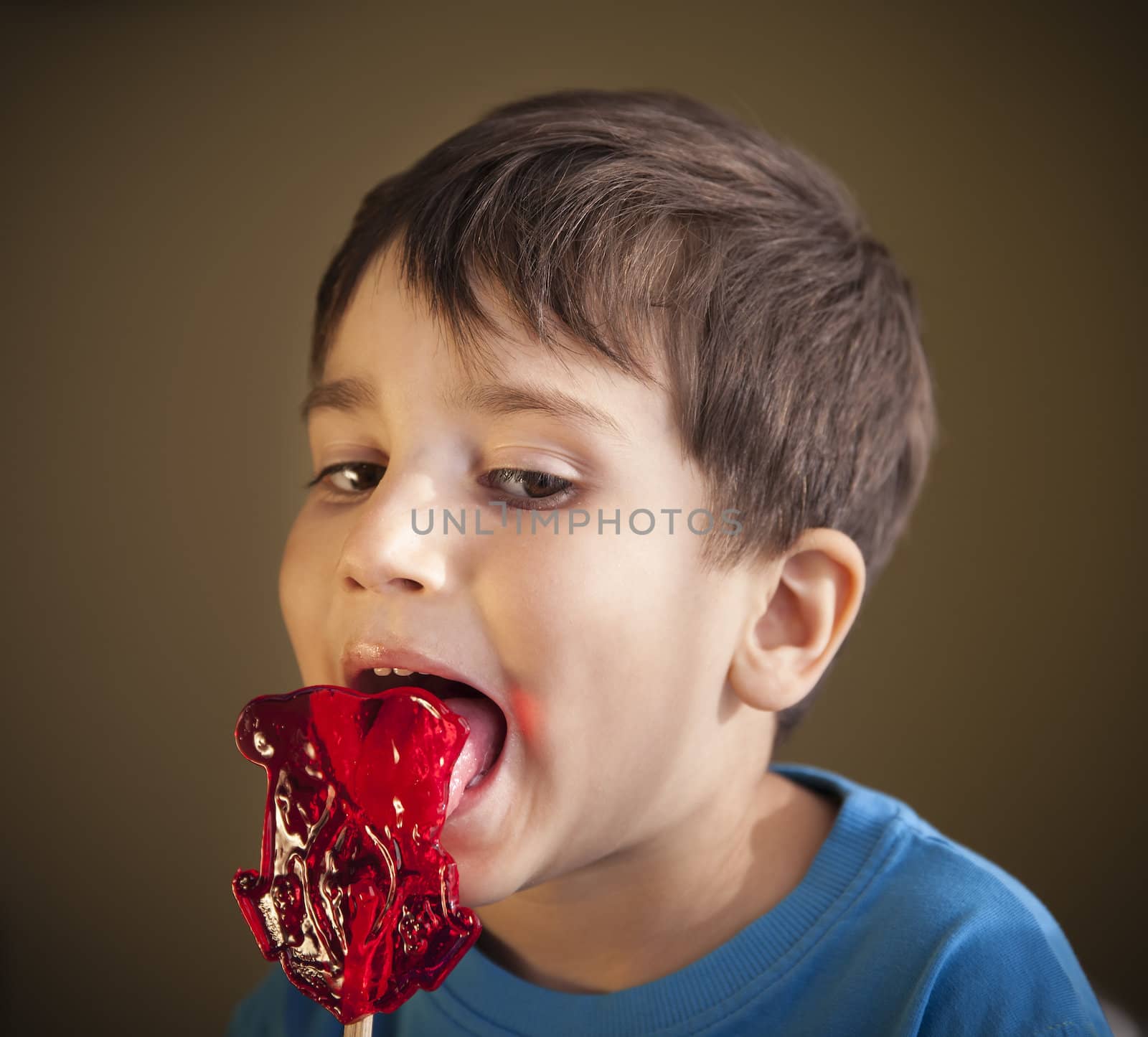 Close Up of Young Boy Eating A Lollipop