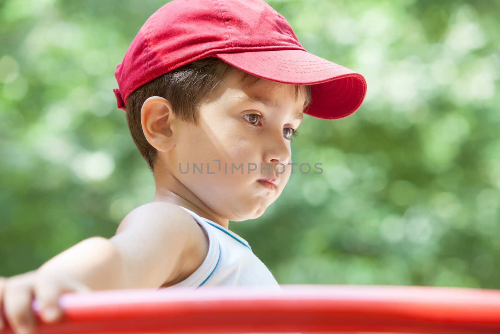 Portrait of a 3-4 years boy playing on the playground