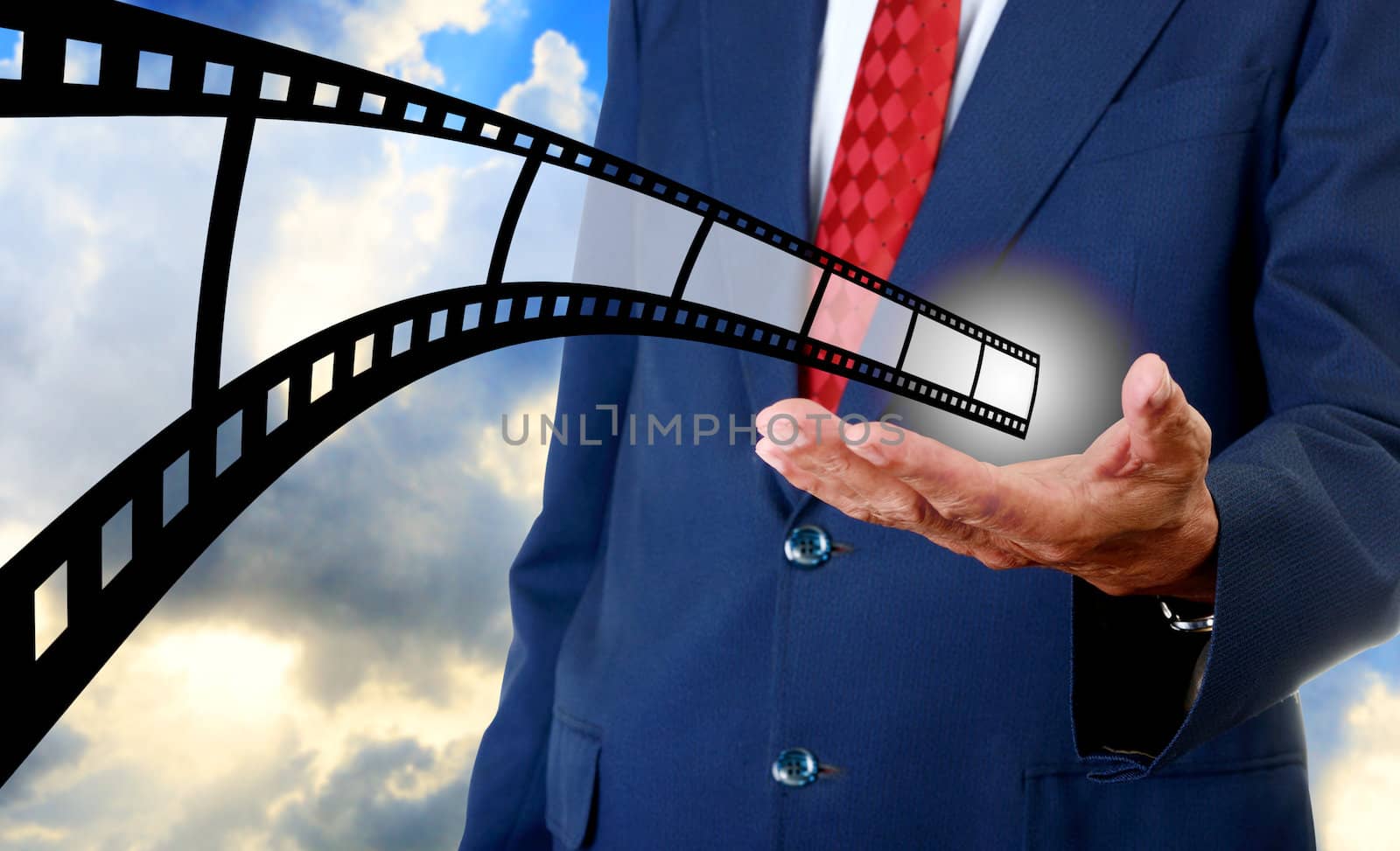 Film strip in businessman hand, Movie industrial