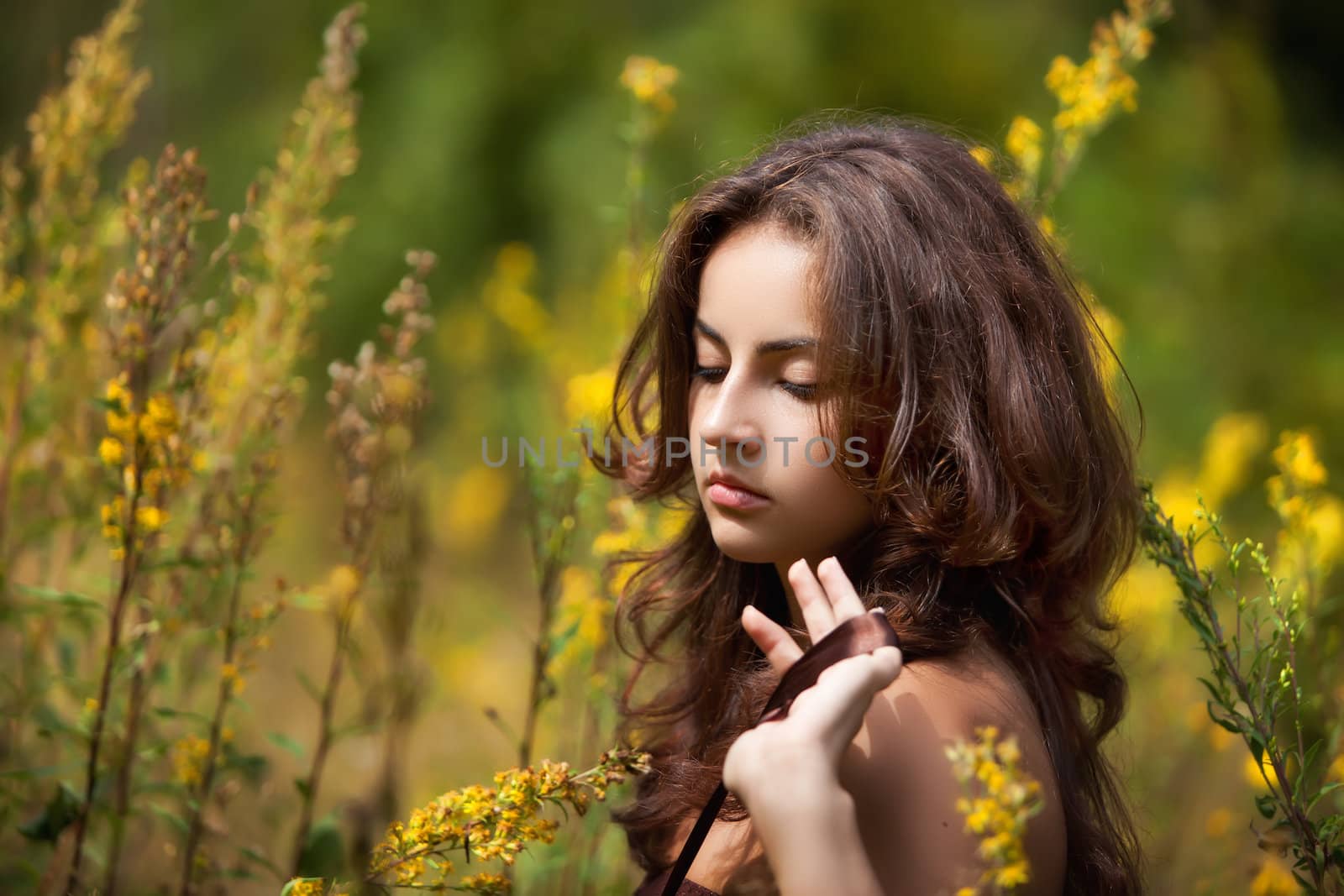 Portrait of a young woman on flowers field by palinchak