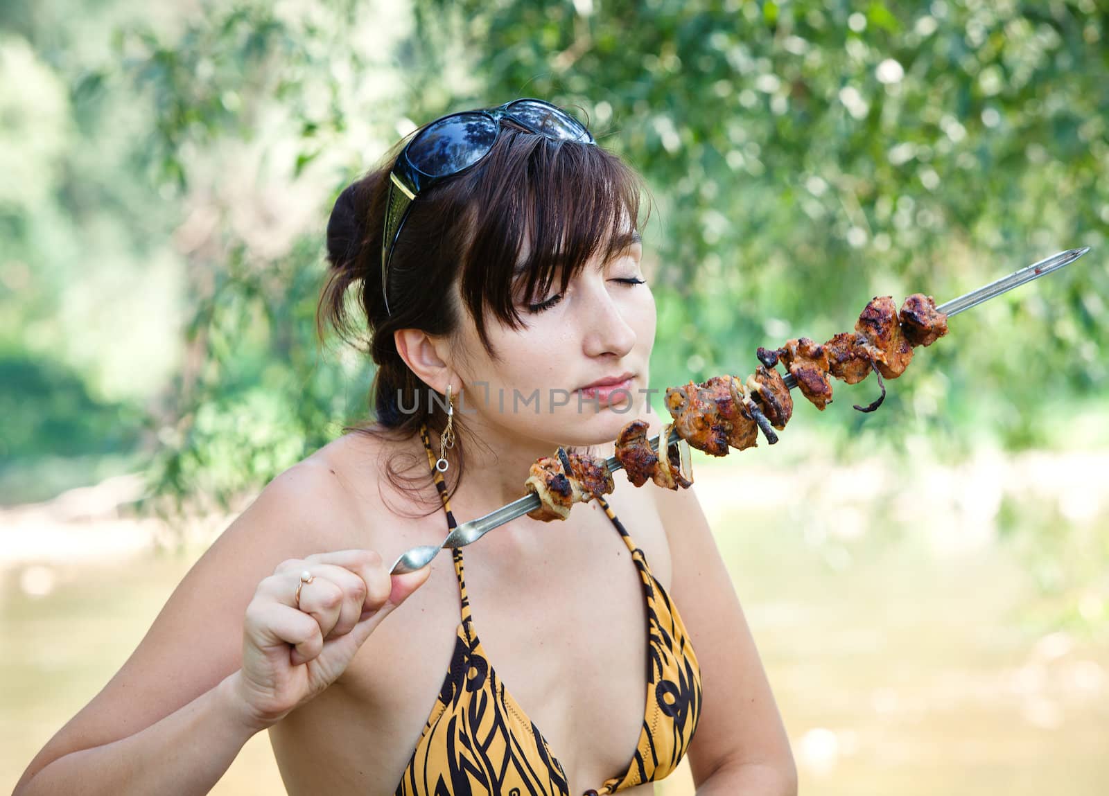 Young woman with grilled meat by palinchak