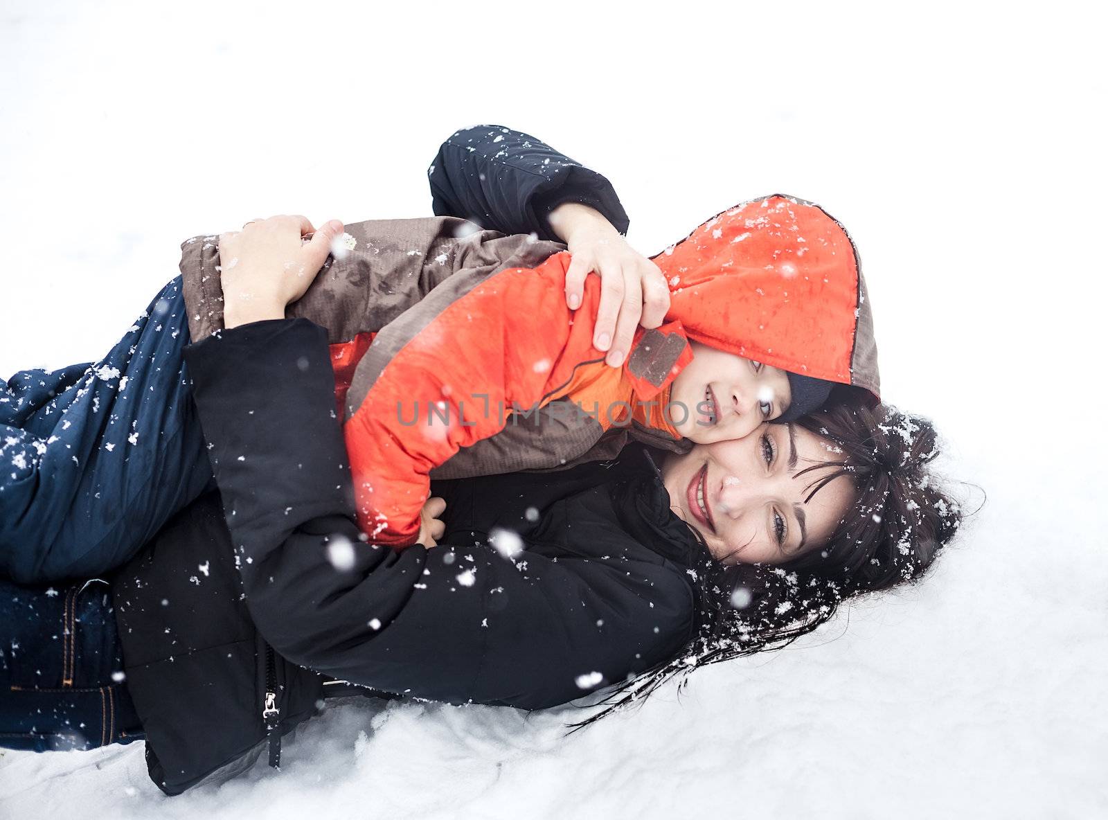 Winter. Mother and child playing in snow