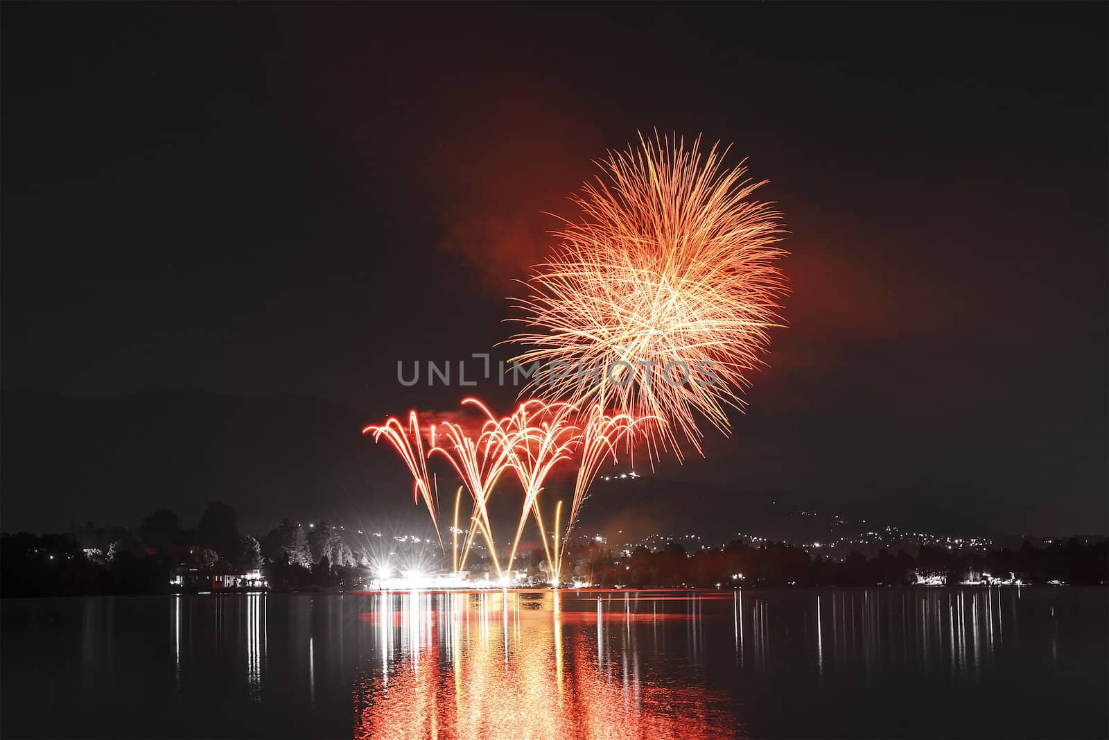 Fireworks on Monate Lake in a summer night, Varese - Italy