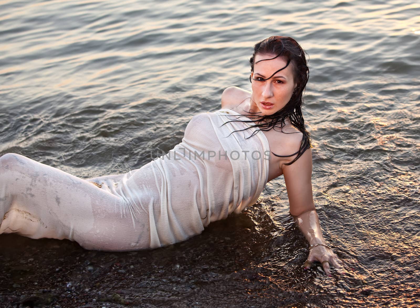 Portrait of a young girl lying in the sea