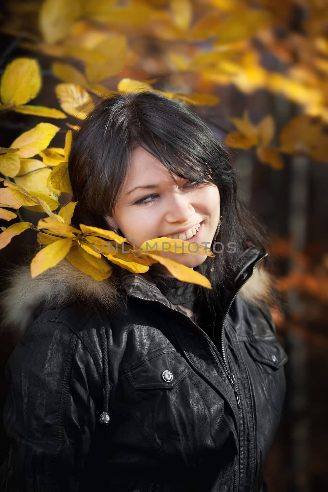 Happy young woman in autumn forest