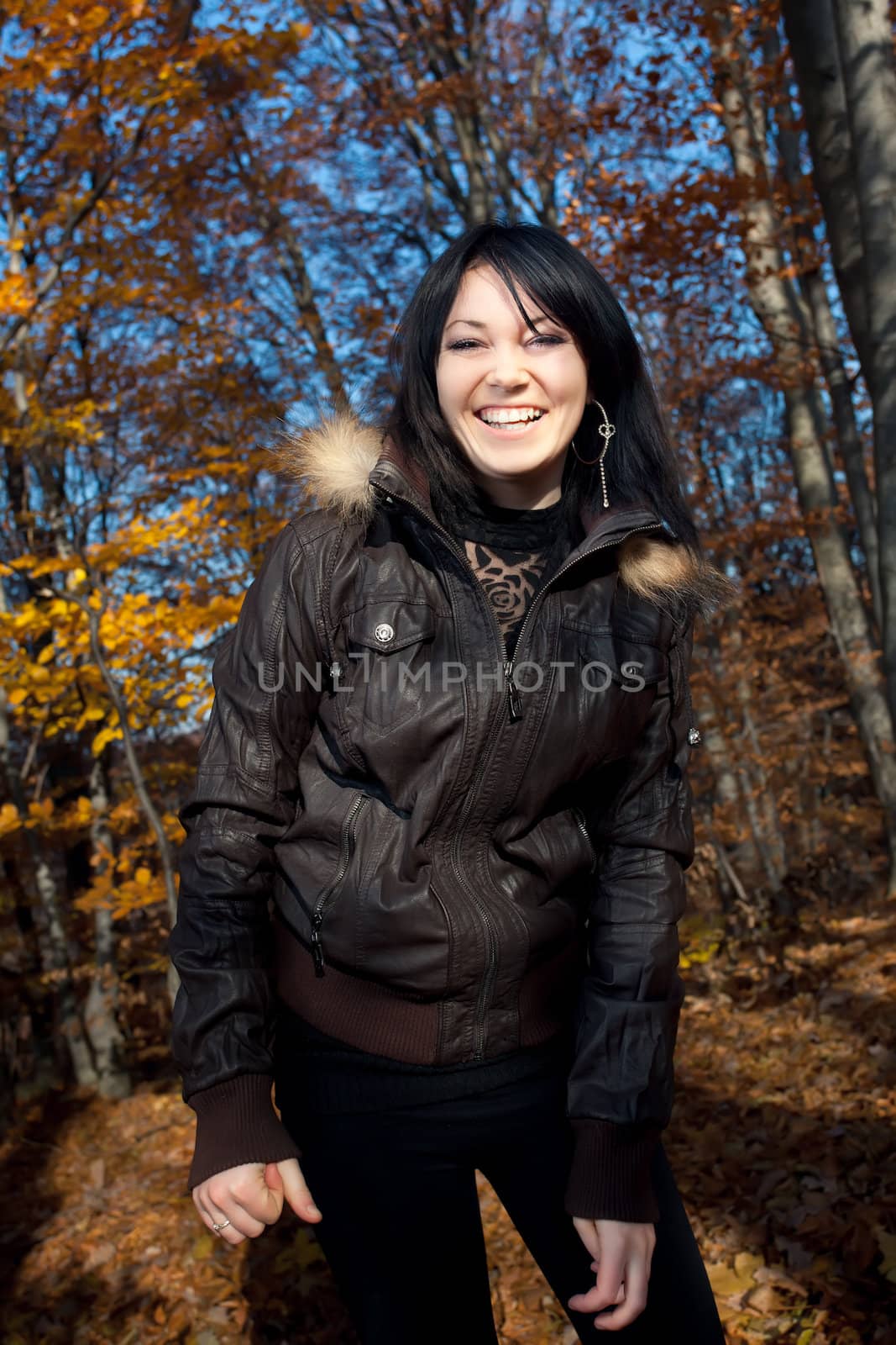 Smiling young woman in autumn forest