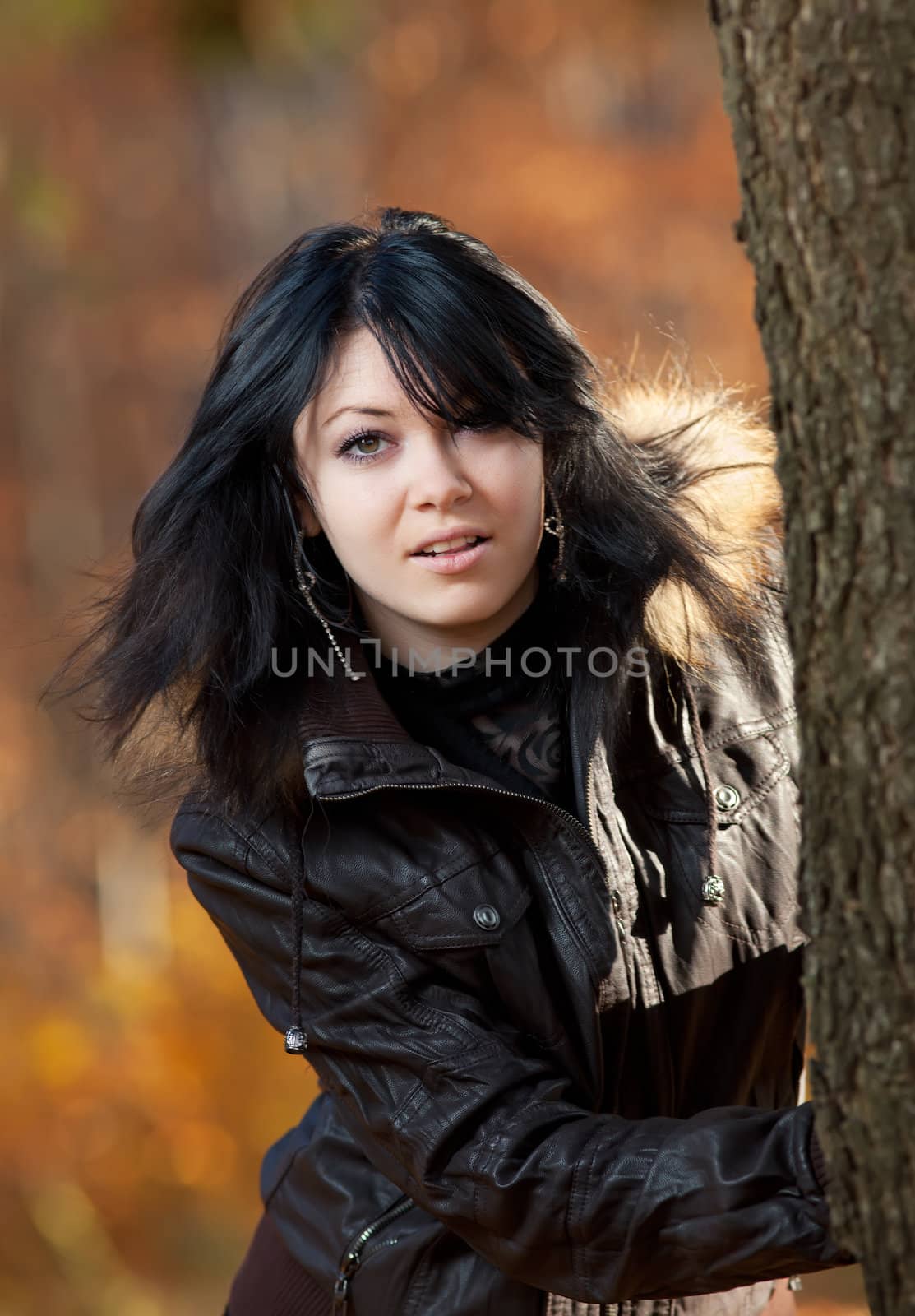 Young woman in a leather jacket looking with interest