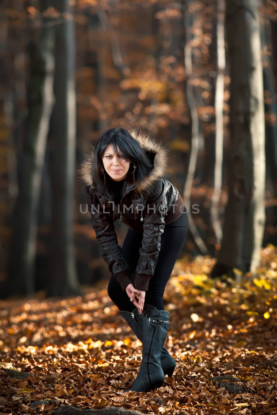 Young woman walking in the autumn forest