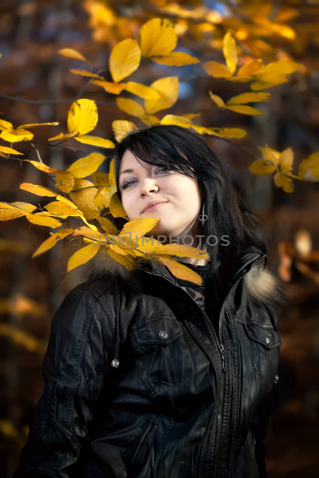 Happy young woman in autumn forest