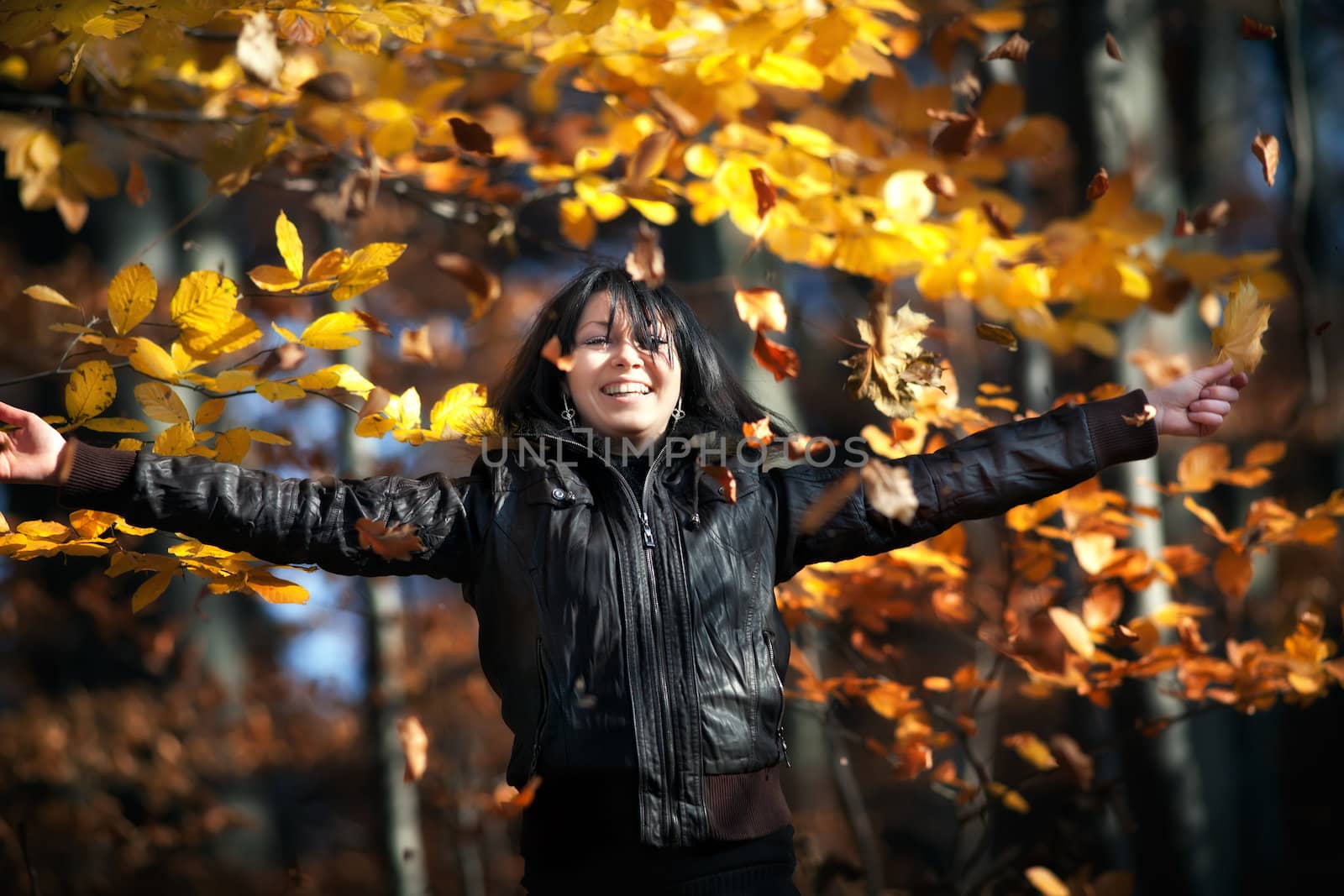 Happy young woman in autumn forest