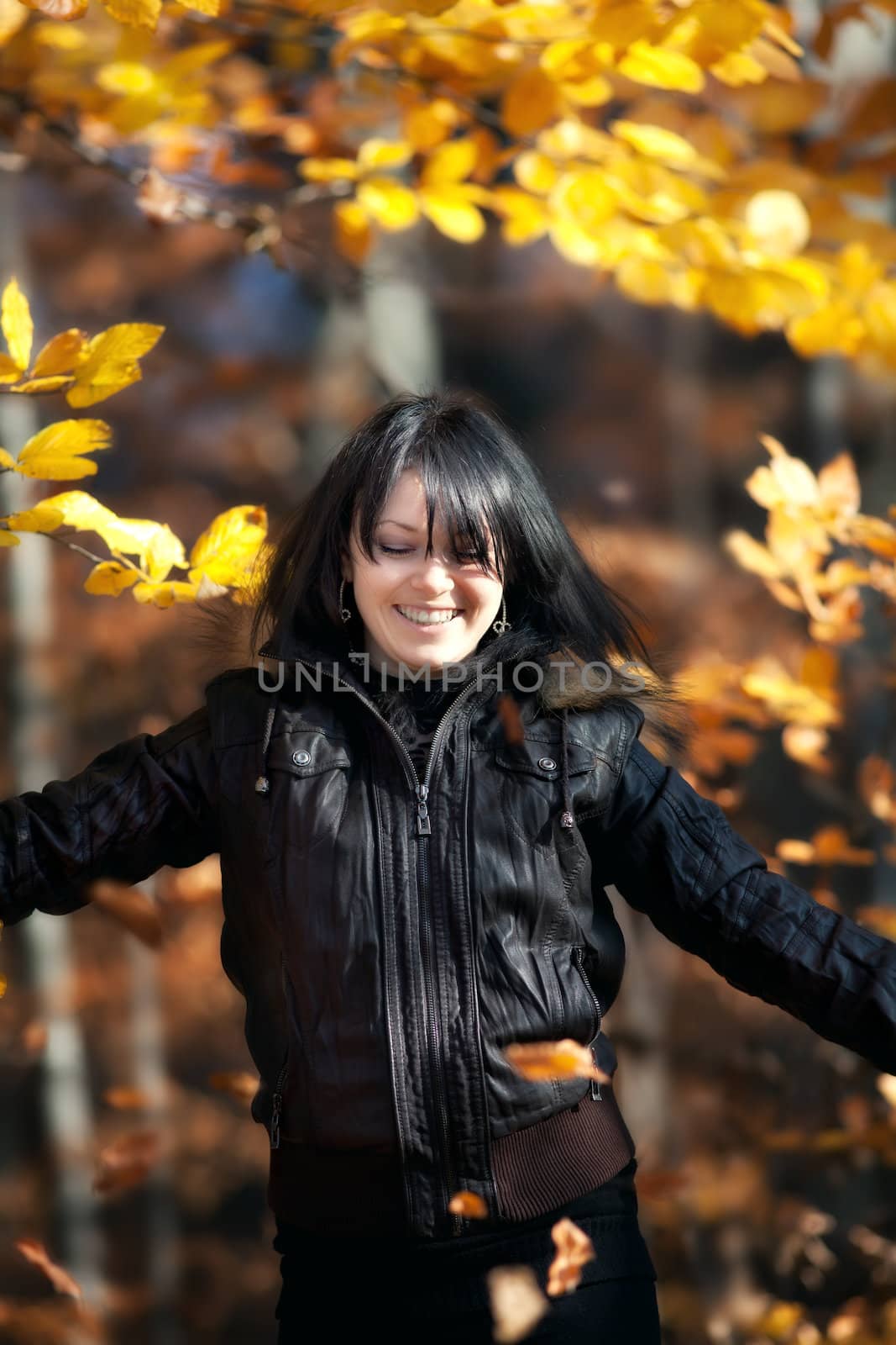 Happy young woman in autumn forest