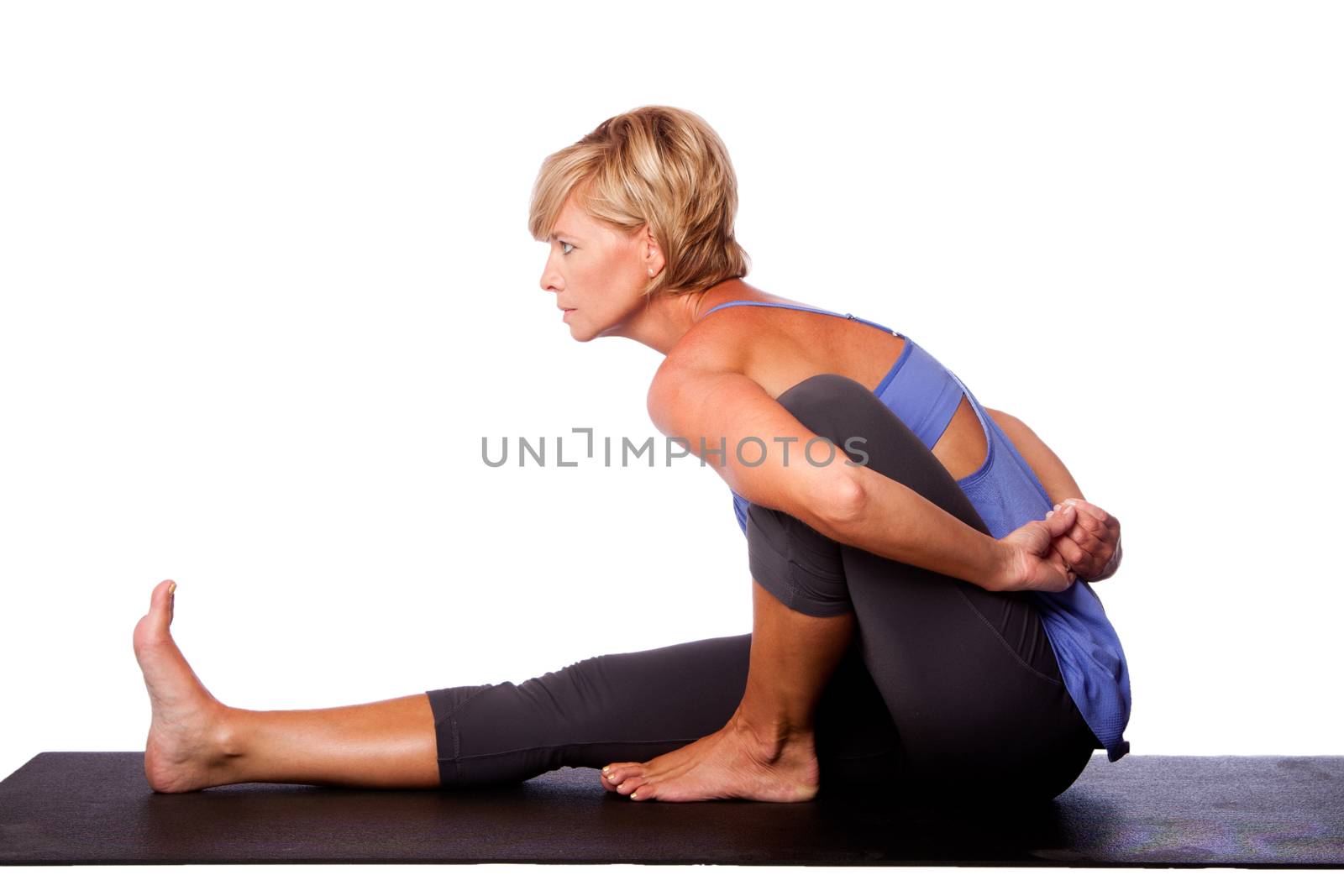 Beautiful woman in Seated Spinal Twist Marichyasana yoga pose stretching leg and spine exercise, isolated.